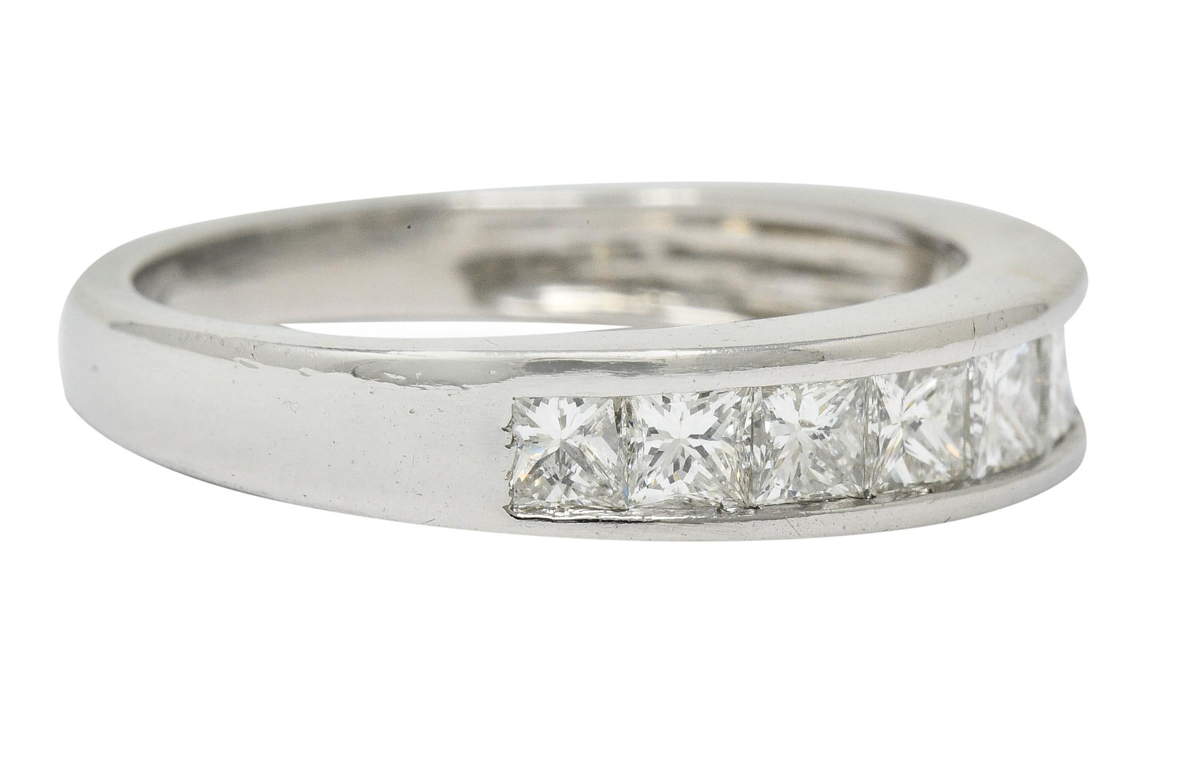 Band ring channel set to front with nine princess cut diamonds, slightly graduating in size

Weighing in total approximately 1.00 carat with I/J color and VS clarity

Completed by polished channel walls

With maker's mark and stamped PT950 for