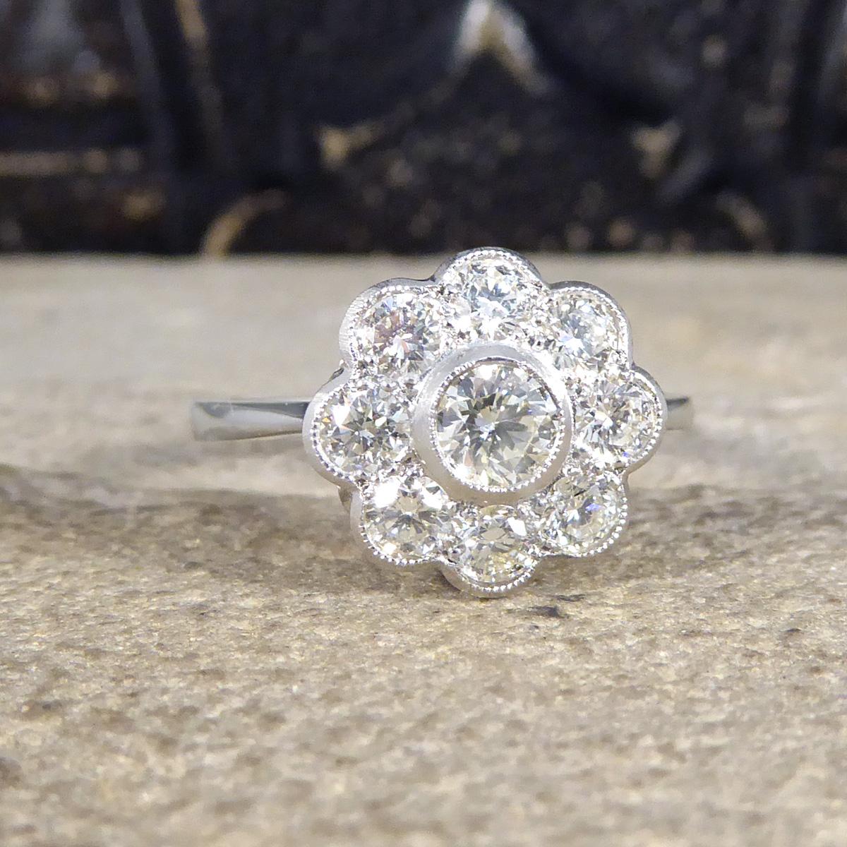 This fabulous Daisy cluster ring has a total of 1.00ct Modern Brilliant cut Diamonds and sparkles with from all angles in its cluster setting. All set in Platinum with a milegrain edge with a beautiful gallery, leading to a plain band and is a true