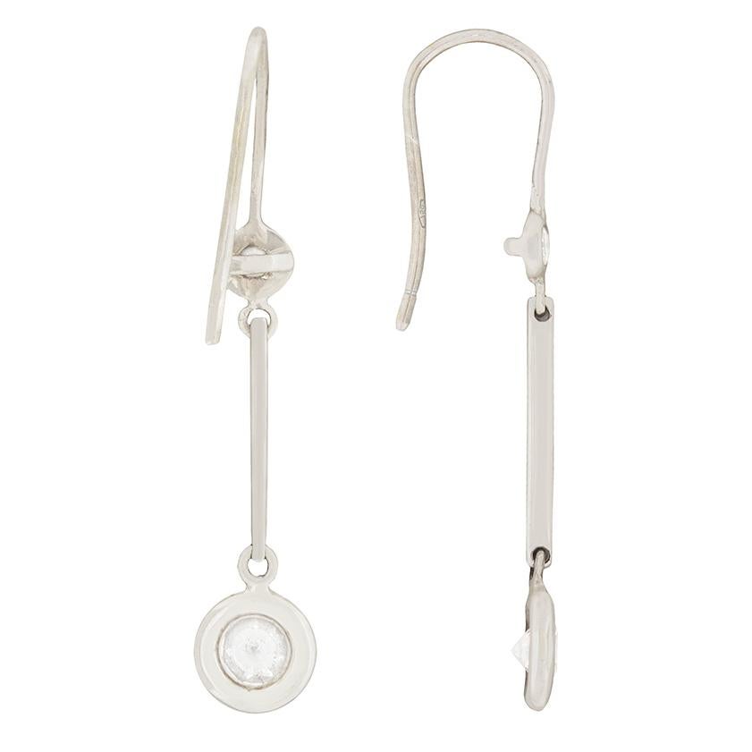 Four sparkling diamonds are elegantly set in these drop earrings. A 0.40 carat diamond is suspended from a 0.10 carat diamond on each earring, totalling to 1.00 carat in the pair. They are G colour and VS clarity and are set in 18 carat white gold.