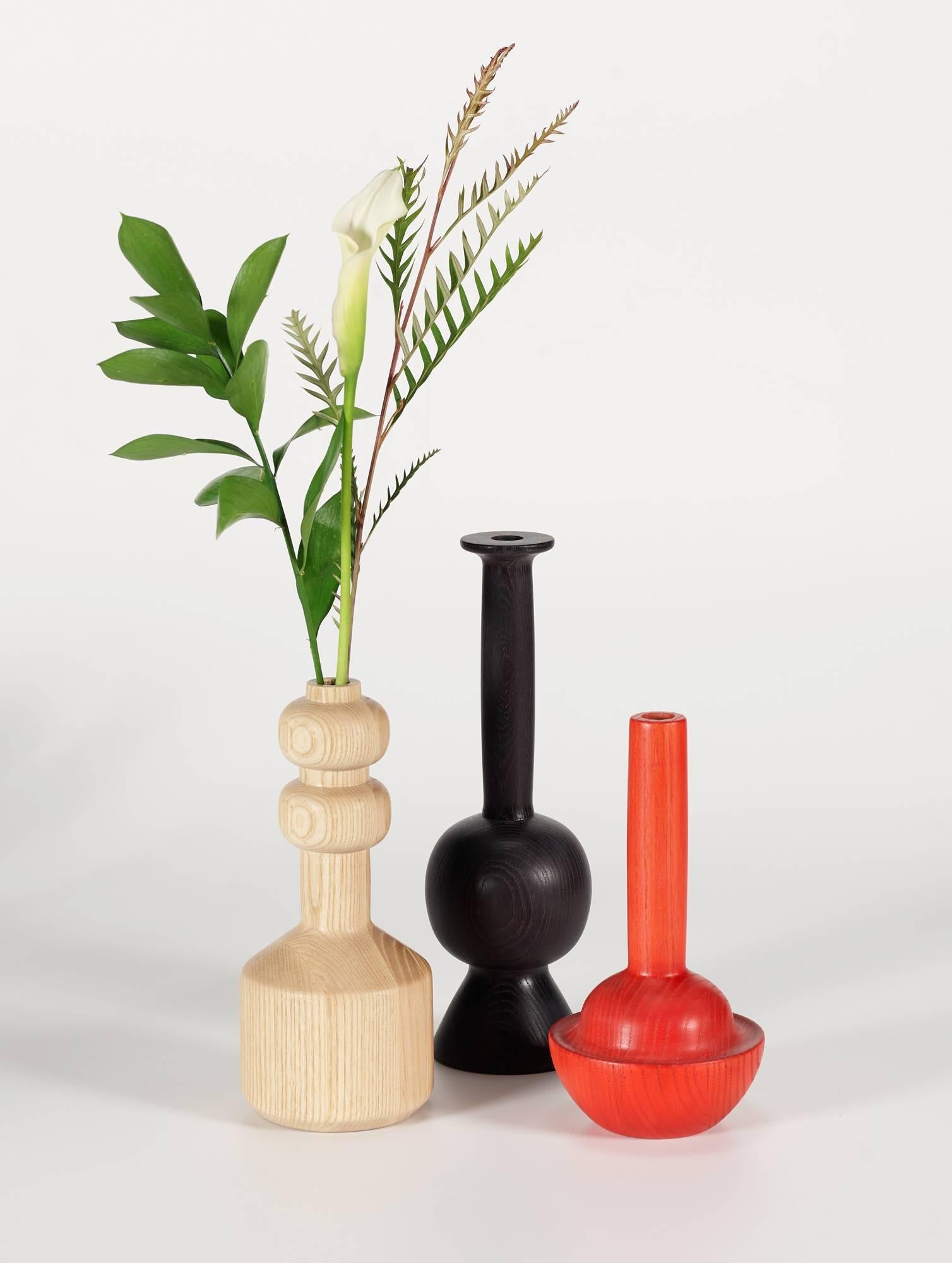 These eno vases reference scientific and laboratory glassware but they are turned in solid wood with a single hole for flowers. They are all made from leftover material from our furniture production so they have a recycled appeal. The interesting