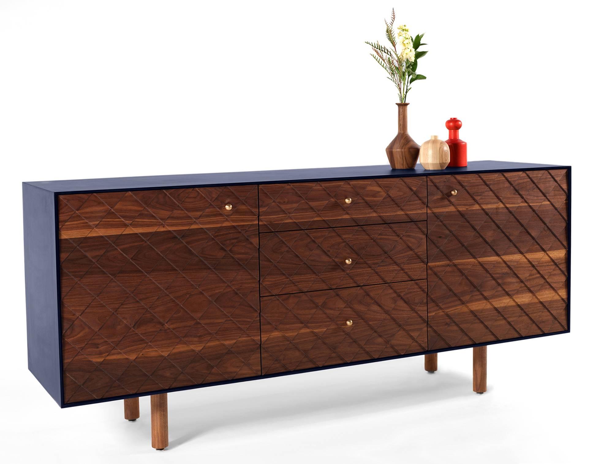Our kragsyde credenza features solid hardwood drawer fronts and doors with a skin of indigo paperstone.
It began as an investigation into applying 3-d surface textures onto hardwood panels and the resulting pattern was inspired by the shingle style