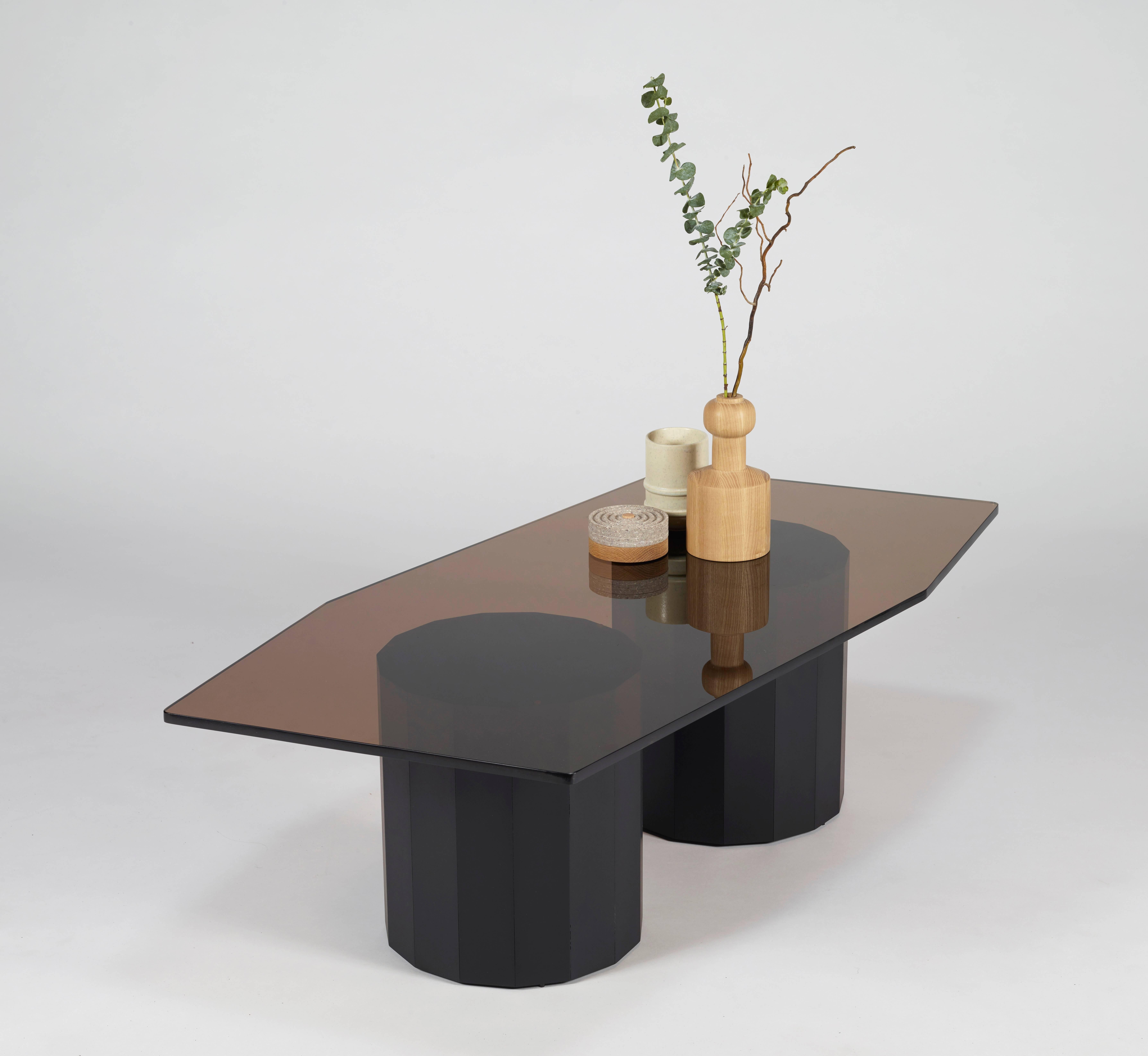 A minimal coffee table with a bronze glass top and a paperstone base.
Inspired by the brutalist architecture of Paul Rudolph with its skewed non-rectilinear top.