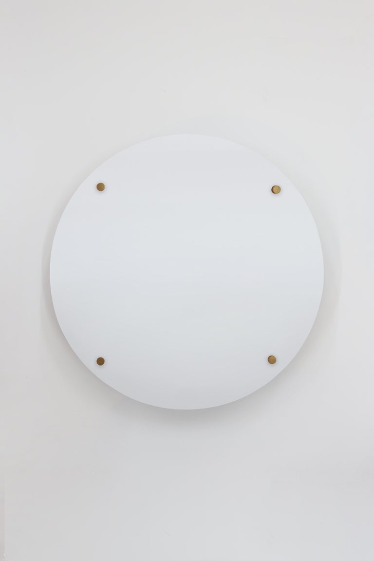 Orphan Work 102PR Sconce
Shown in primed wood with brushed brass. 
Prepped for paint, plaster or wallpaper application. 
Available in white primer with brushed brass or blackened.
Measures: 13” diameter x 3 5/8” depth (Back 9”H x 9”W)
Wall or