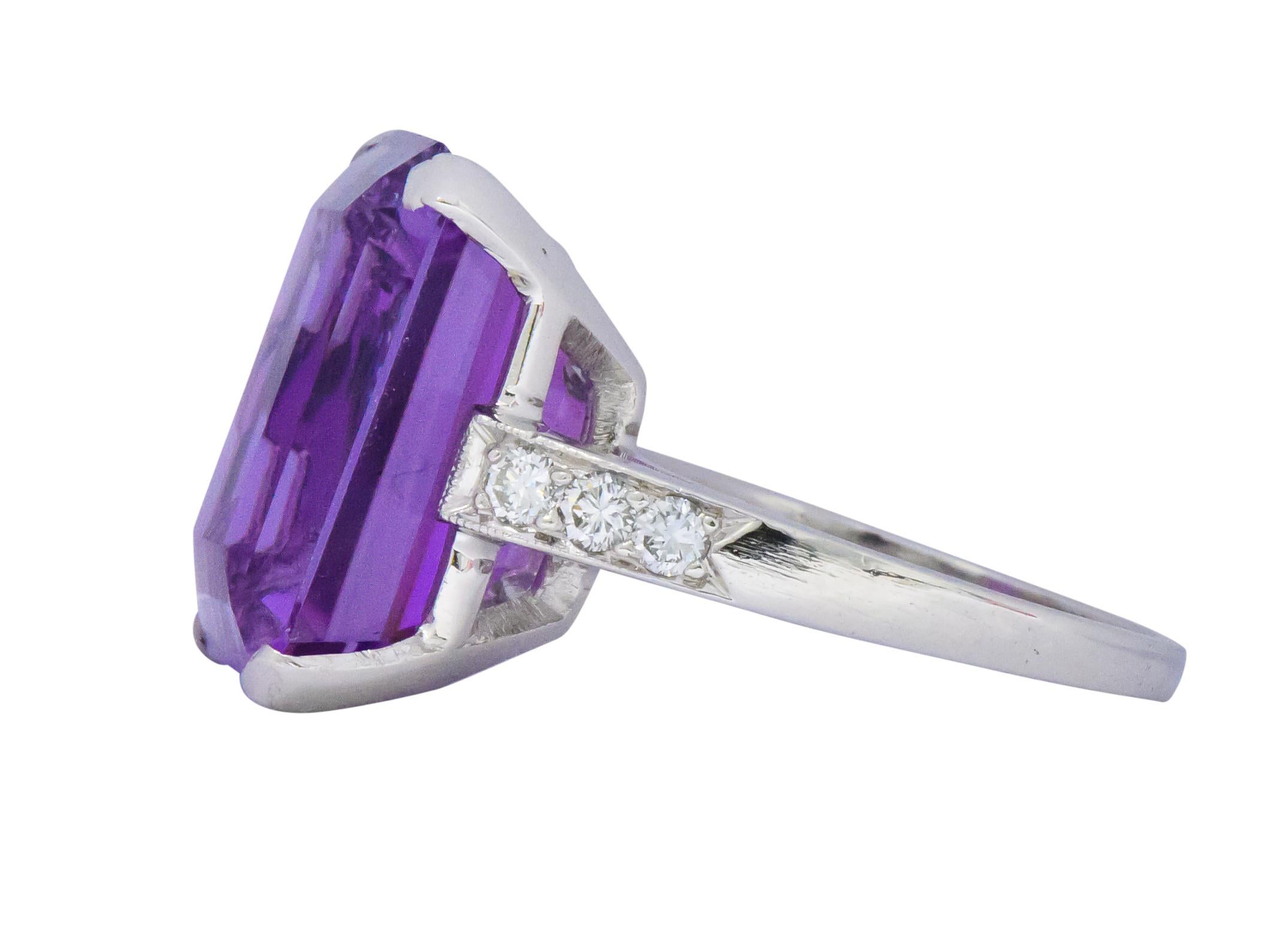 Centering an emerald cut amethyst weighing approximately 10.75 carats total, even bright vivid purple  

Accented by 3 round brilliant cut diamonds on each side, weighing approximately 0.25 carats total, G/H color and VS clarity

Extraordinary color