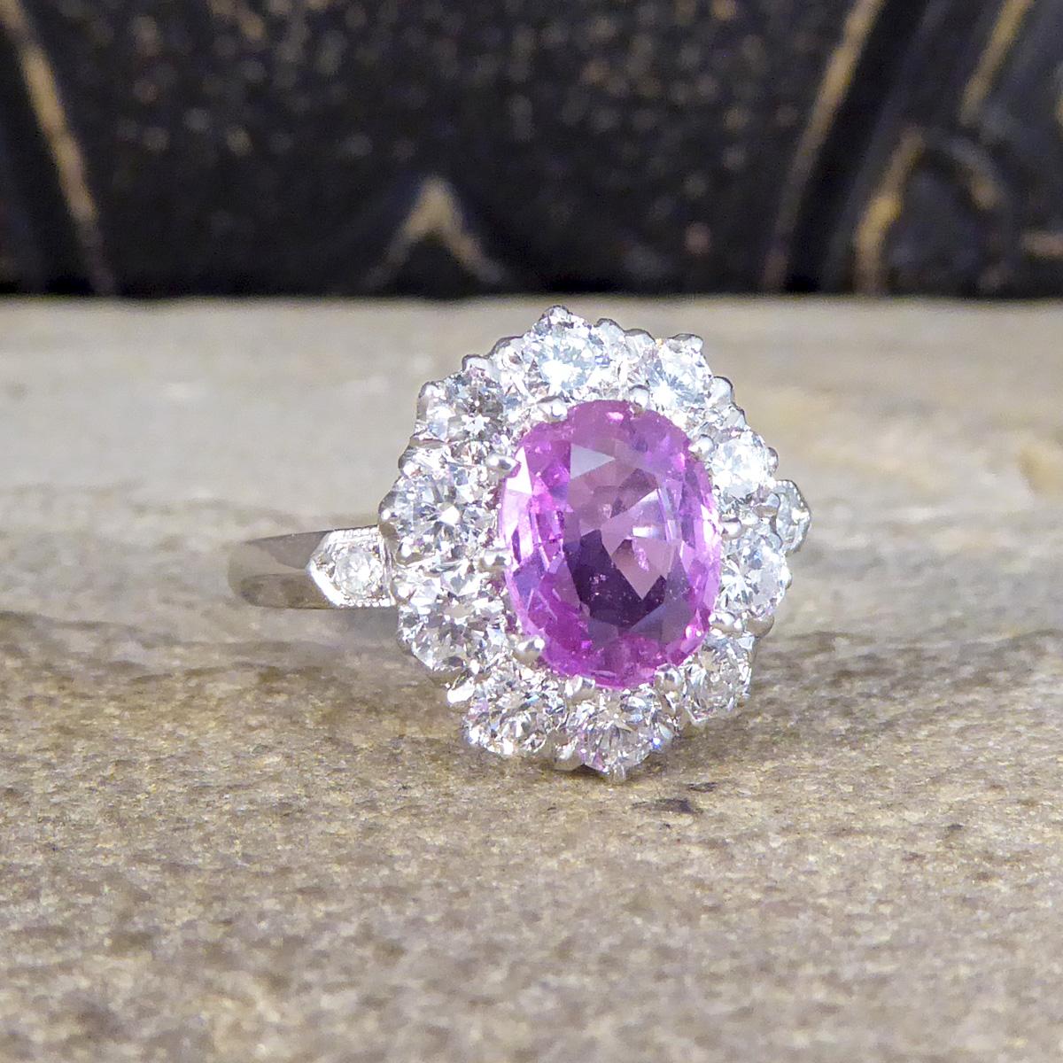 This contemporary ring has been crafted to resemble an Edwardian style ring. A 1.15ct stunning Pink Sapphire in the centre of the ring and surrounded by a halo of 10 Brilliant Cut Diamonds weighing a grand total of 1.00ct giving it a brilliant