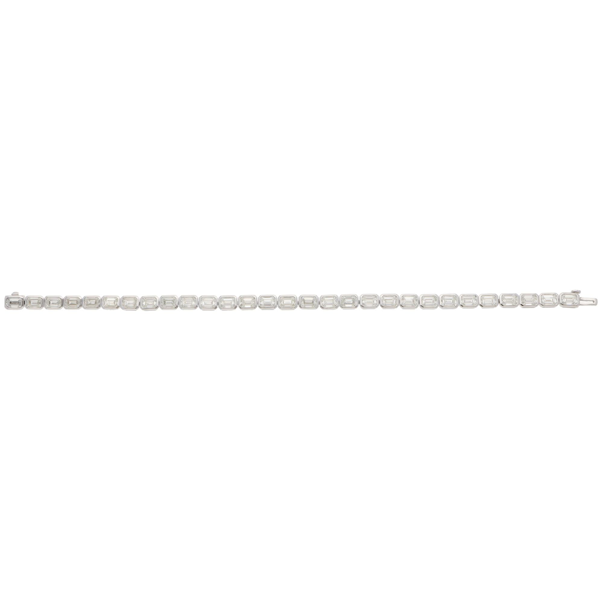 A beautiful contemporary emerald-cut diamond line tennis bracelet set in 18k white gold.

The bracelet is composed of a grand total of 29 emerald-cut diamonds. All stones are securely bezel set and perfectly matched in size. The bracelet is secured