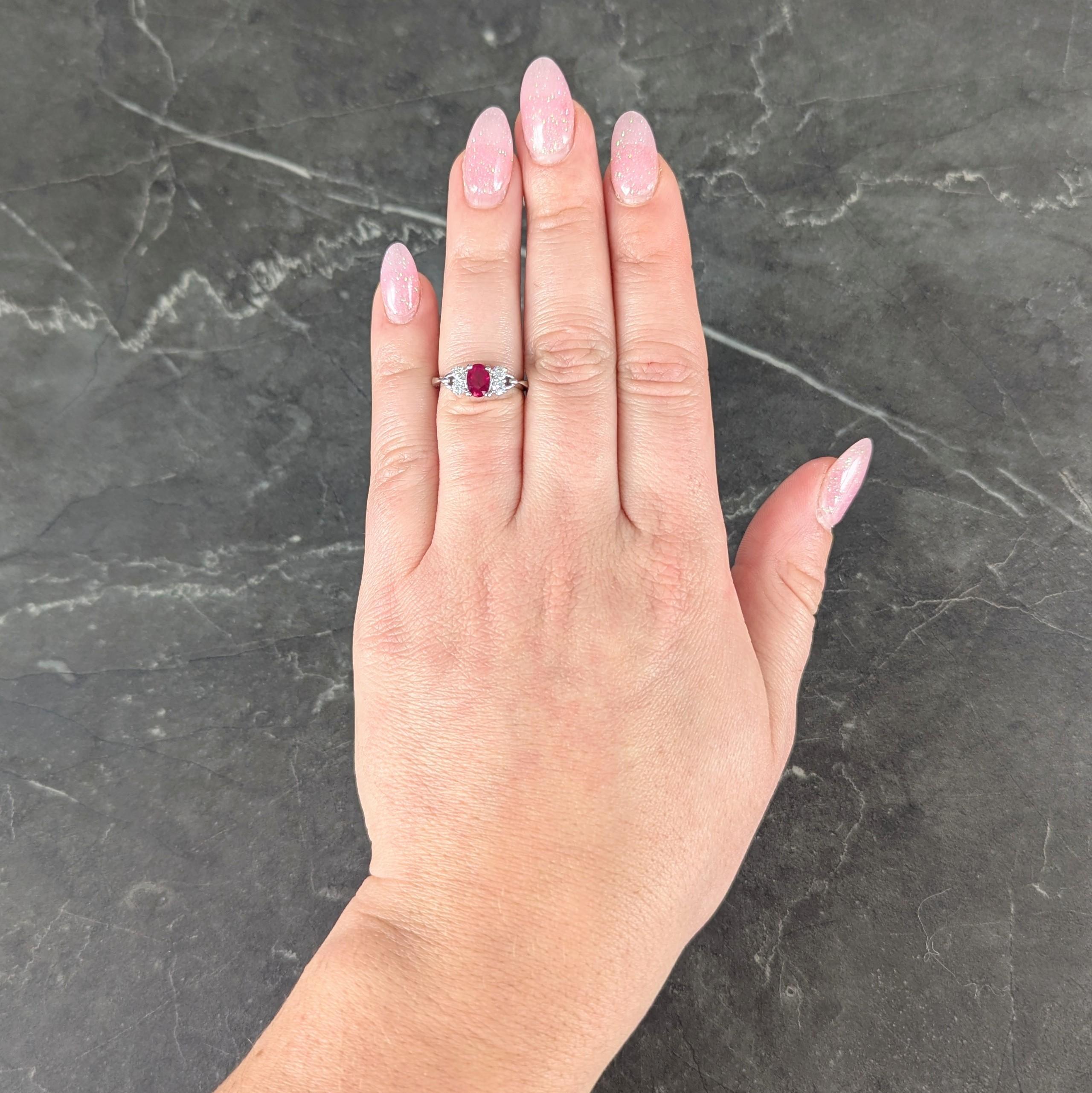 Centering an oval cut ruby weighing 0.88 carat total - transparent medium purplish pink
Prong set in basket and flanked by clustered round brilliant cut diamonds
Weighing approximately 0.32 carat total - G color with VS2 clarity
Prong set in pierced