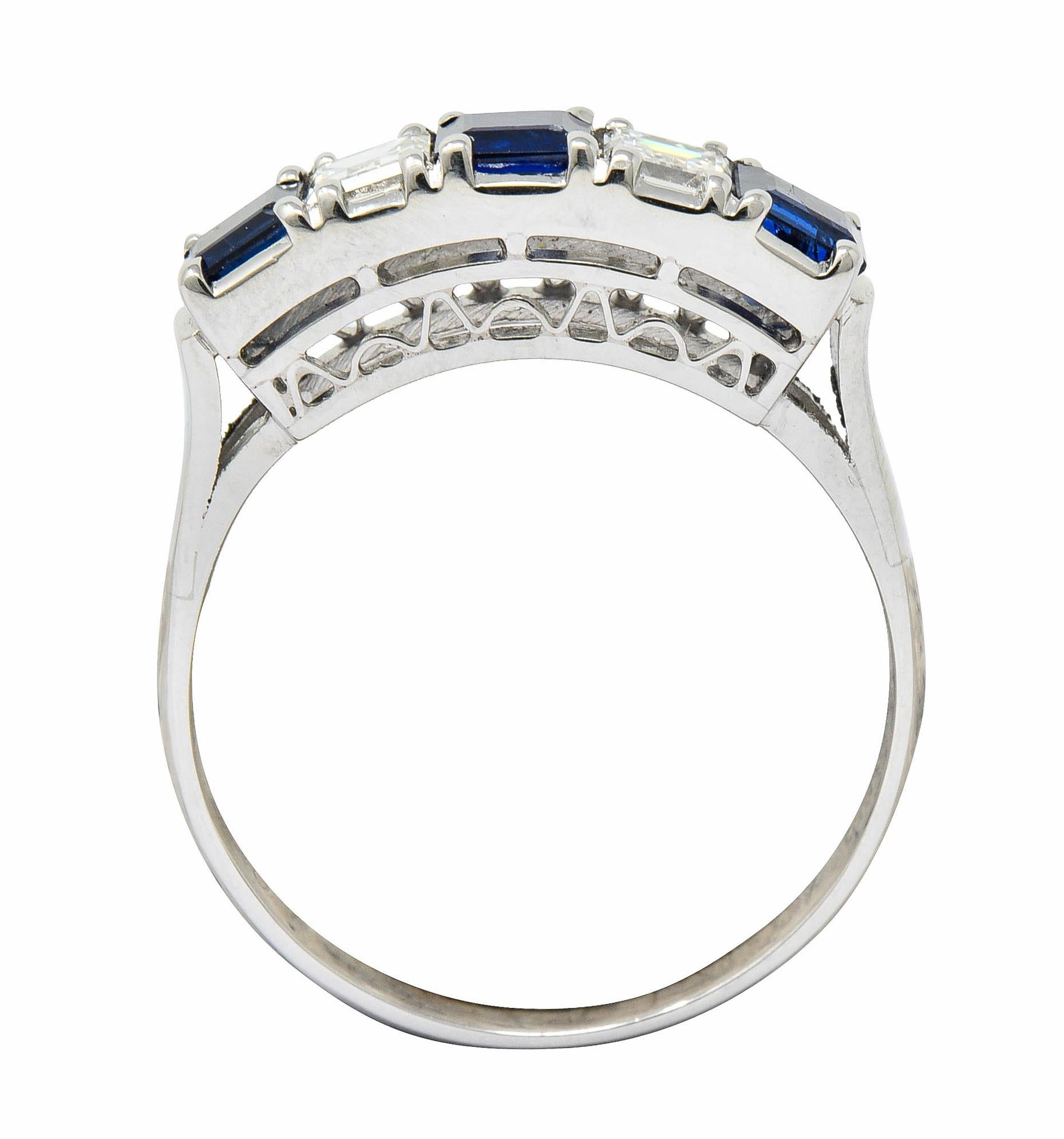 Band ring is set to front by rectangular cut sapphire and rectangular step cut diamonds

Sapphires are a well-matched medium-dark royal blue and weigh in total approximately 0.91 carat

Alternating with diamonds weighing in total approximately 0.40