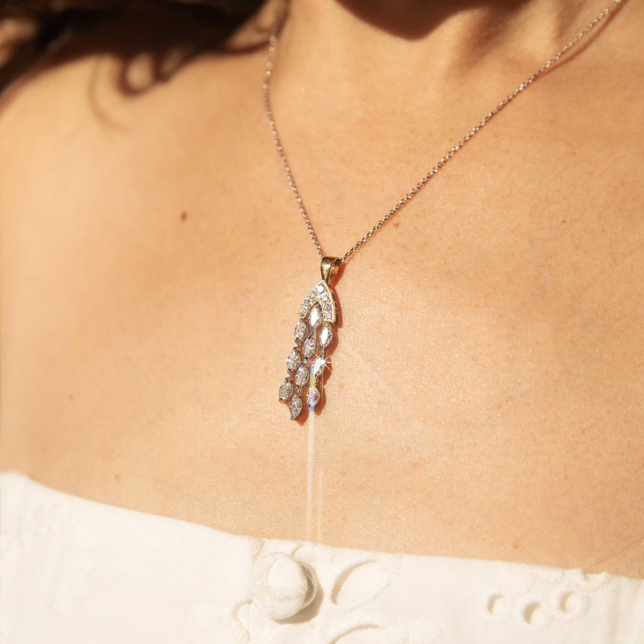 A cascading chandelier of light, each diamond held within our gorgeous Kiran Pendant is a star in a constellation of gold. Meticulously crafted in 18-carat gold, she whispers of timeless elegance and captivating allure. With every delicate movement,