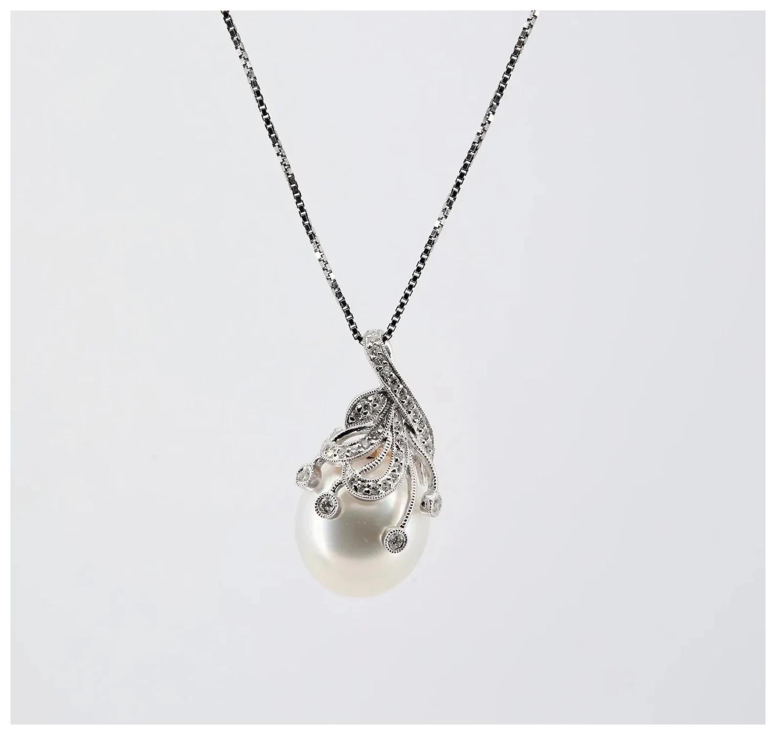 A contemporary South Sea Pearl and diamond pendant in 18 karat white gold.

The 13mm south sea pearl of iridescent white color with very good luster.

Pave set with 0.20 carats total of round brilliant cut diamonds of G color, SI1 clarity.

Tested