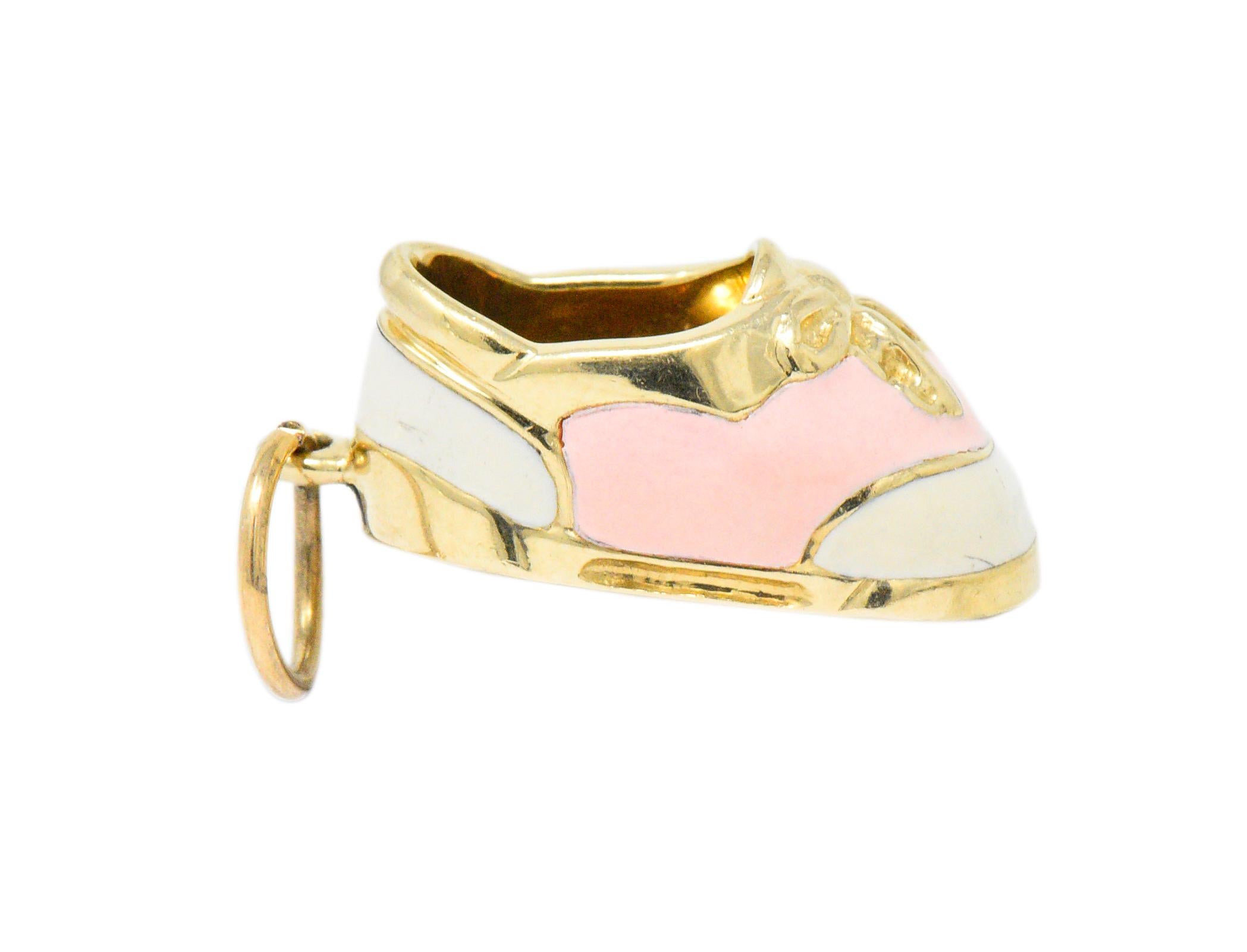 Featuring a dimensional 14k gold charm depicting a saddle shoe with laces tied in a bow

Adorned with pale pink and cream enameling

Measuring 11/16