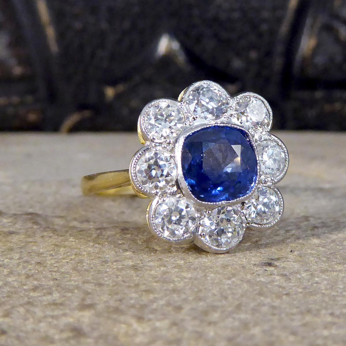 This gorgeous Sapphire and Diamond cluster ring has been crafted from 18ct White and Yellow Gold, with the White Gold on the surface complimenting the colour of the stones, leading to a full 18ct Yellow Gold band. Featuring a 1.40ct beautiful bright