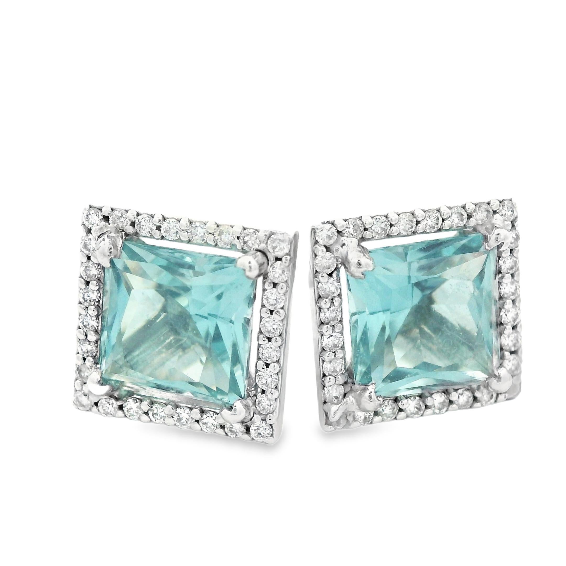 This exceptional pair of aquamarine and diamond stud earrings made in 14k white gold. They feature 2 carats of brilliant square cut natural beryl blue aquamarine. They have an amazing look that is sure to turn heads. Perfect for anyone whose