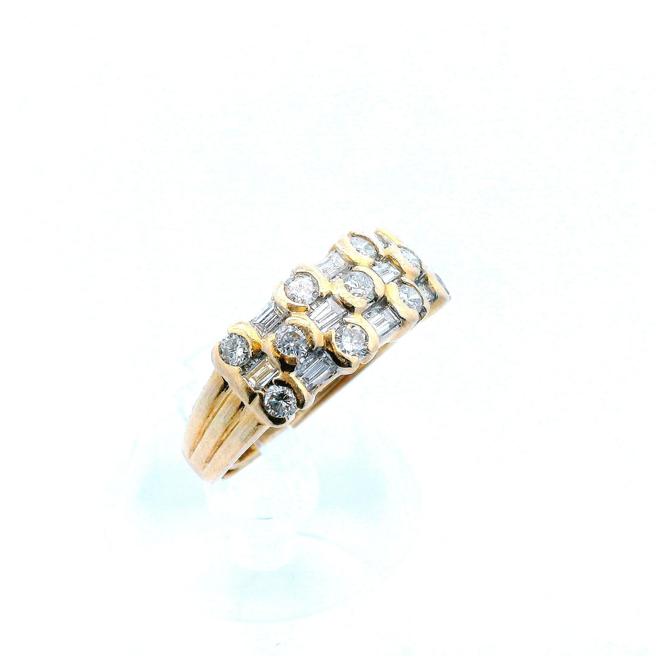This contemporary ring, made in 14k yellow gold and featuring both baguette and round cut diamonds, is incredible. The unique design comes from alternating layout of the baguette and round cut diamonds and creates a nugget look that gives the ring