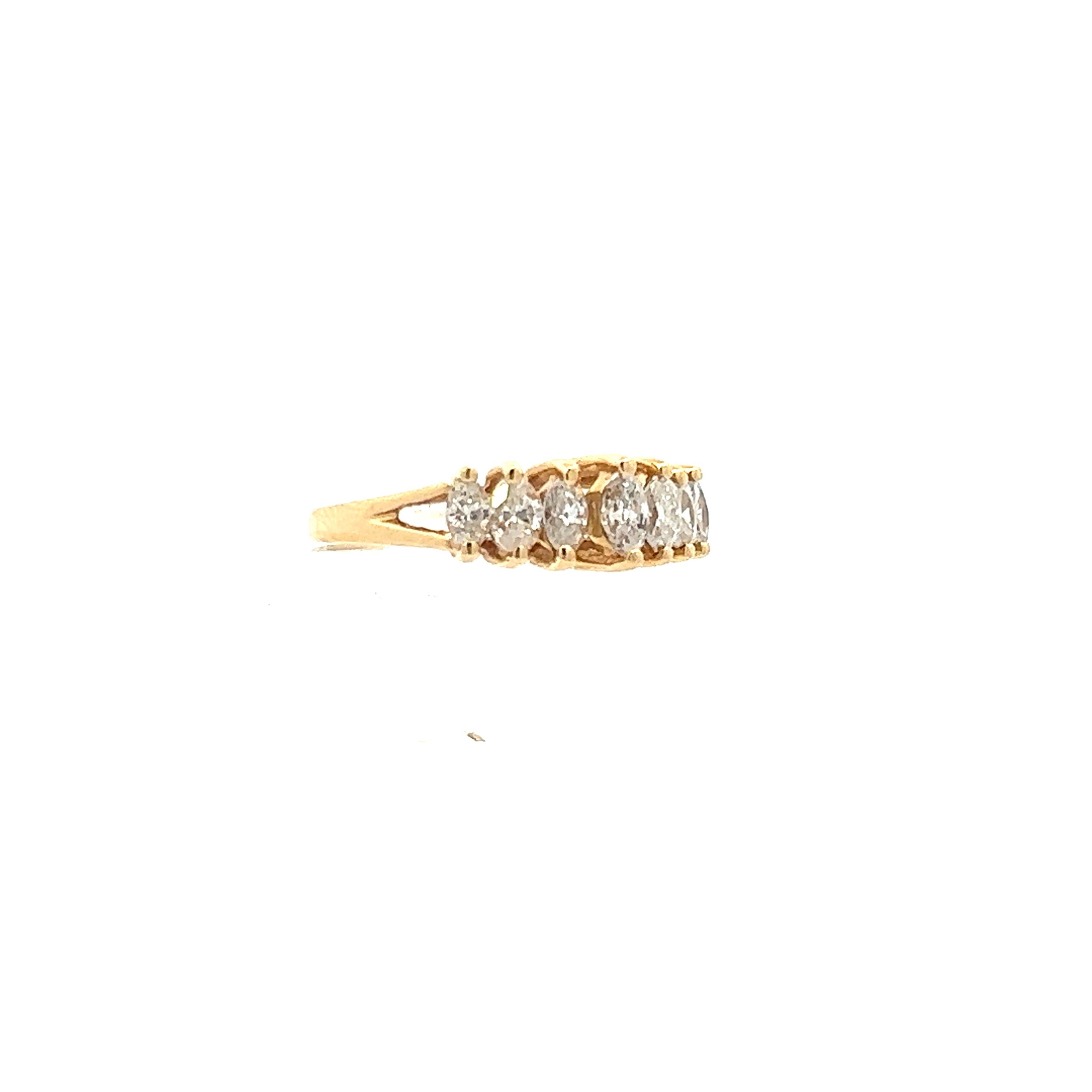 This stunning contemporary ring is made in 14k yellow gold and features marquise diamonds. The design of this 14k yellow gold ring is unique as there are 7 total marquise diamonds in a raised setting, with negative space between each, allowing for