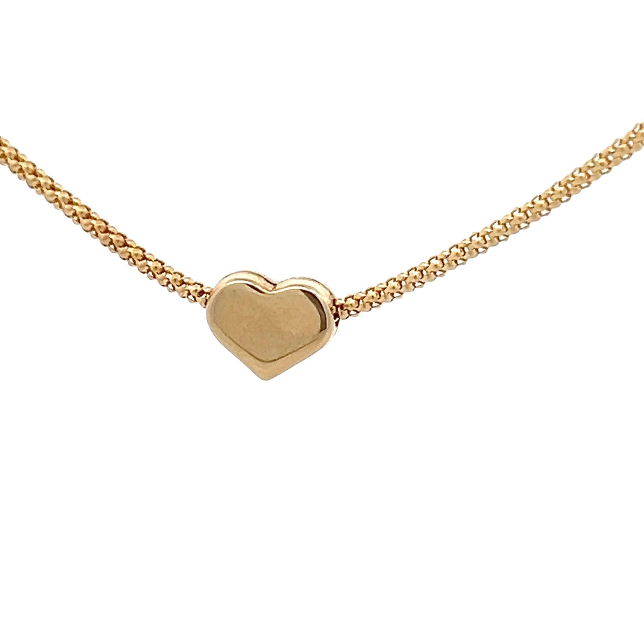 This  beautiful contemporary necklace is made in 14k yellow gold and features a sliding heart over a popcorn style chain. The classic 14k yellow gold heart paired with the modern popcorn chain provide this necklace with a modern, yet elegant theme.