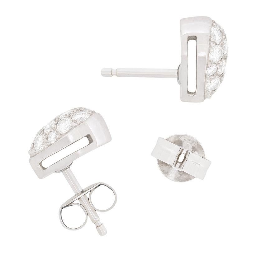 A dazzling pair of contemporary heart-shaped earrings paved with diamonds! The glittering array of well-matched round brilliant cut diamond totals to 1.50 carats. They are pavé set in 18 carat white gold to stunning effect in these romantic open