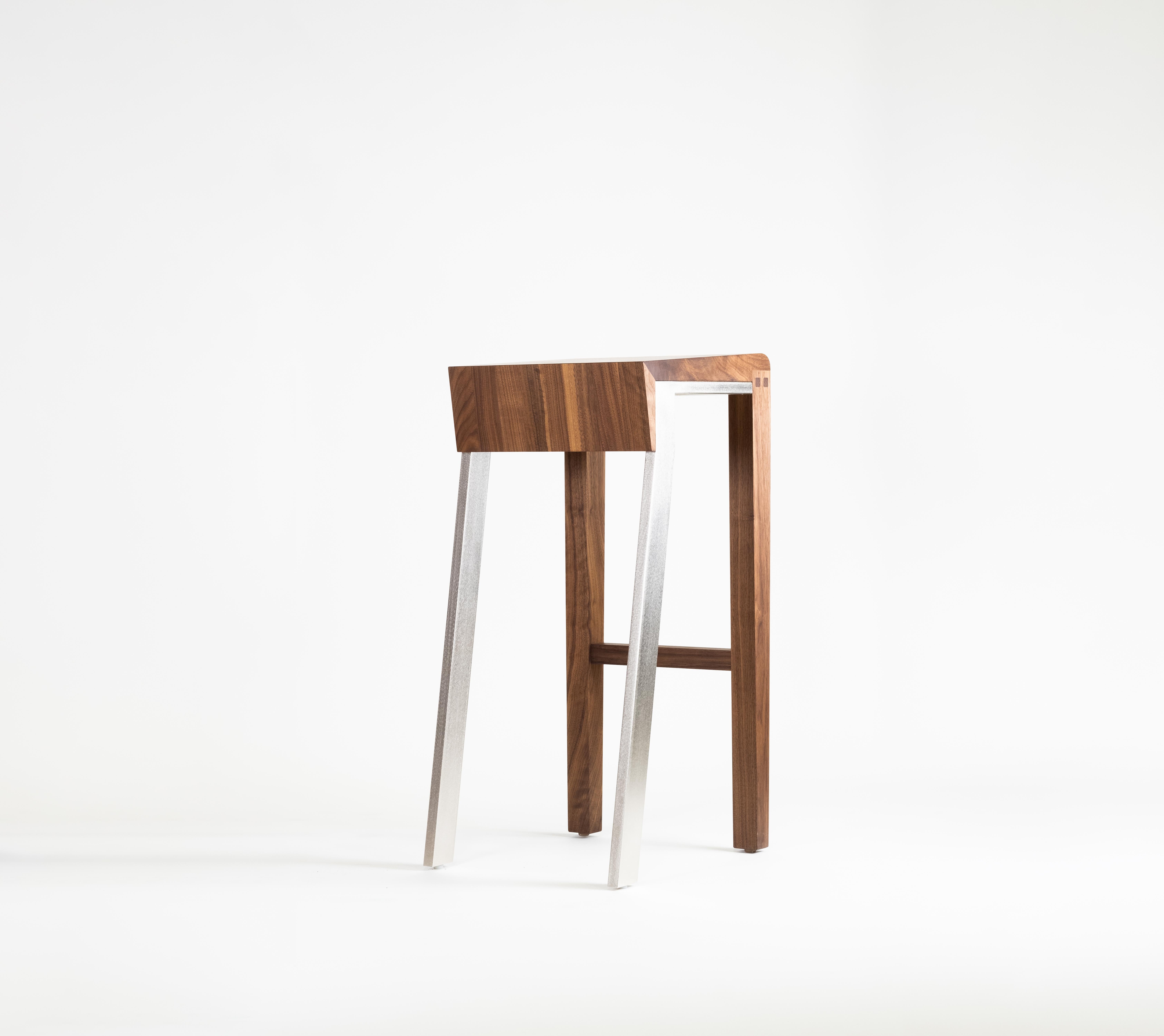 1.6 is a counter-height stool made using joined solid domestic hardwood and plated steel, featuring a combination of traditional and contemporary joinery. The slightly different appearance of each joined board generates unusual variety and gives the