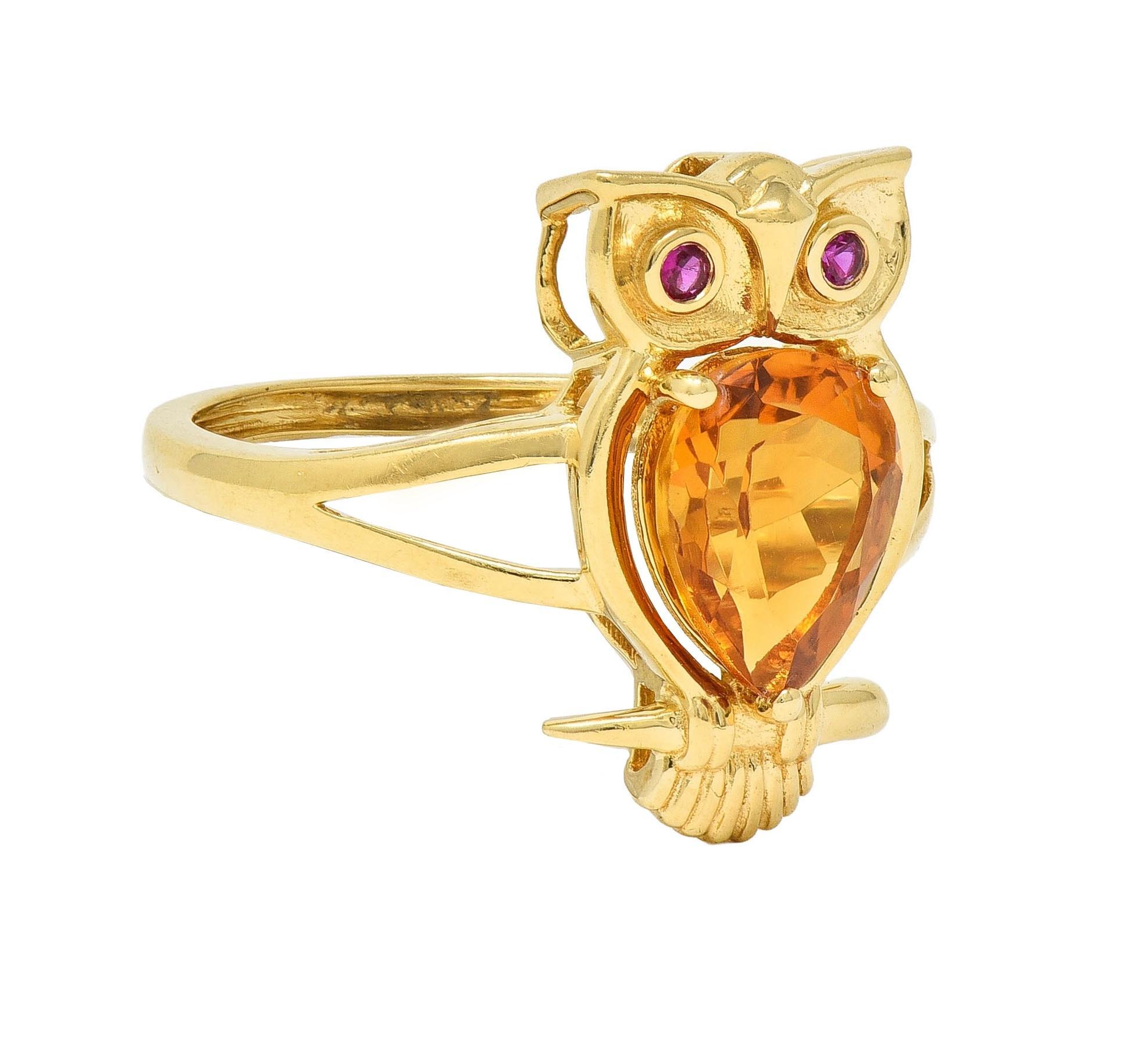 Designed as a stylized owl with pierced and grooved features 
Centering a pear cut citrine body weighing 1.60 carats
Transparent medium brownish orange - prong set
Accented by round cut rubies bezel set as eyes 
Weighing 0.03 carat total -