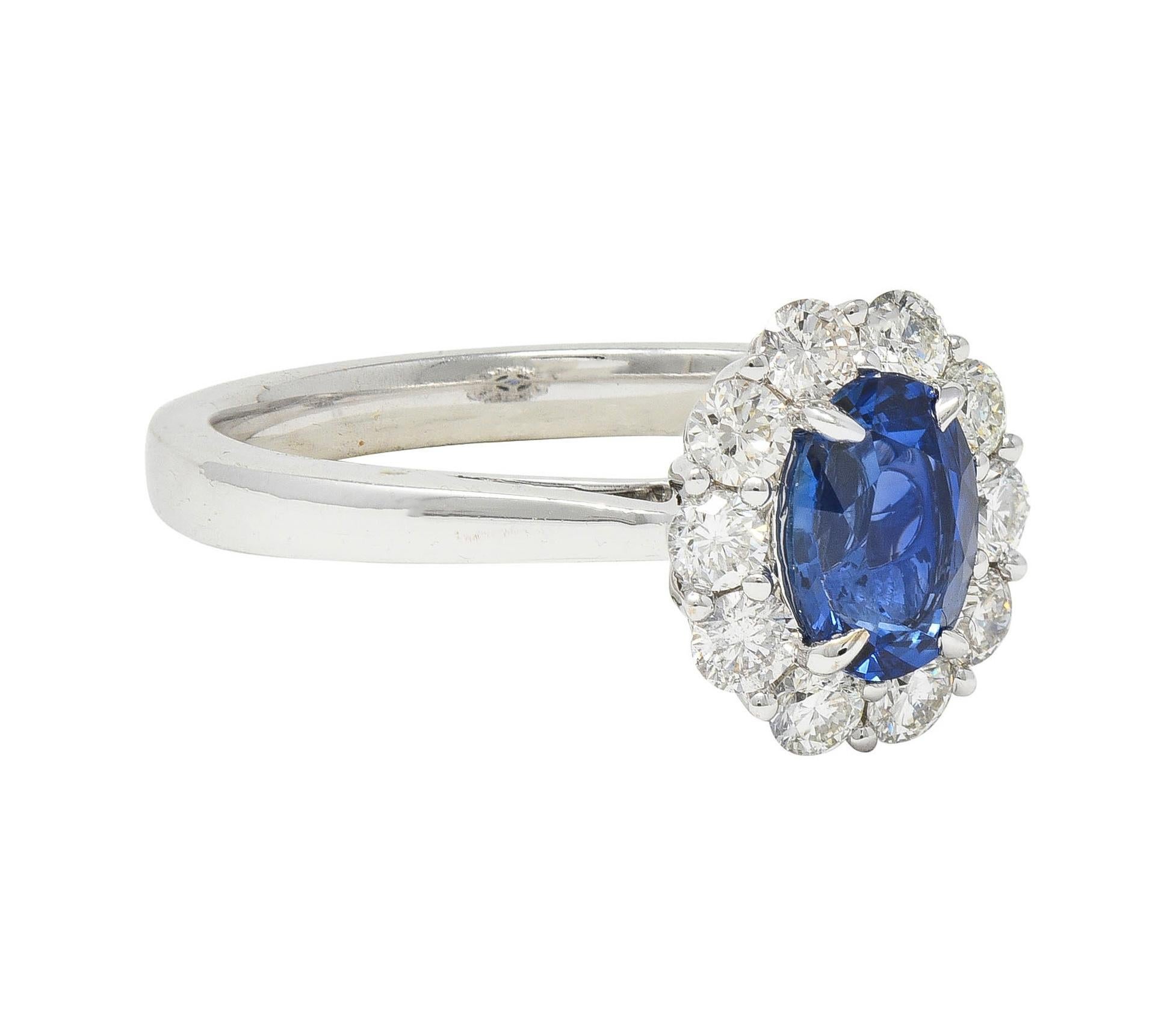 Centering anal cut sapphire weighing approximately 0.97 carat - transparent vibrant blue 
Set with talon prongs accented by a halo surround of round brilliant cut diamonds
With additional diamonds bead set in a pierced milgrain gallery 
Weighing