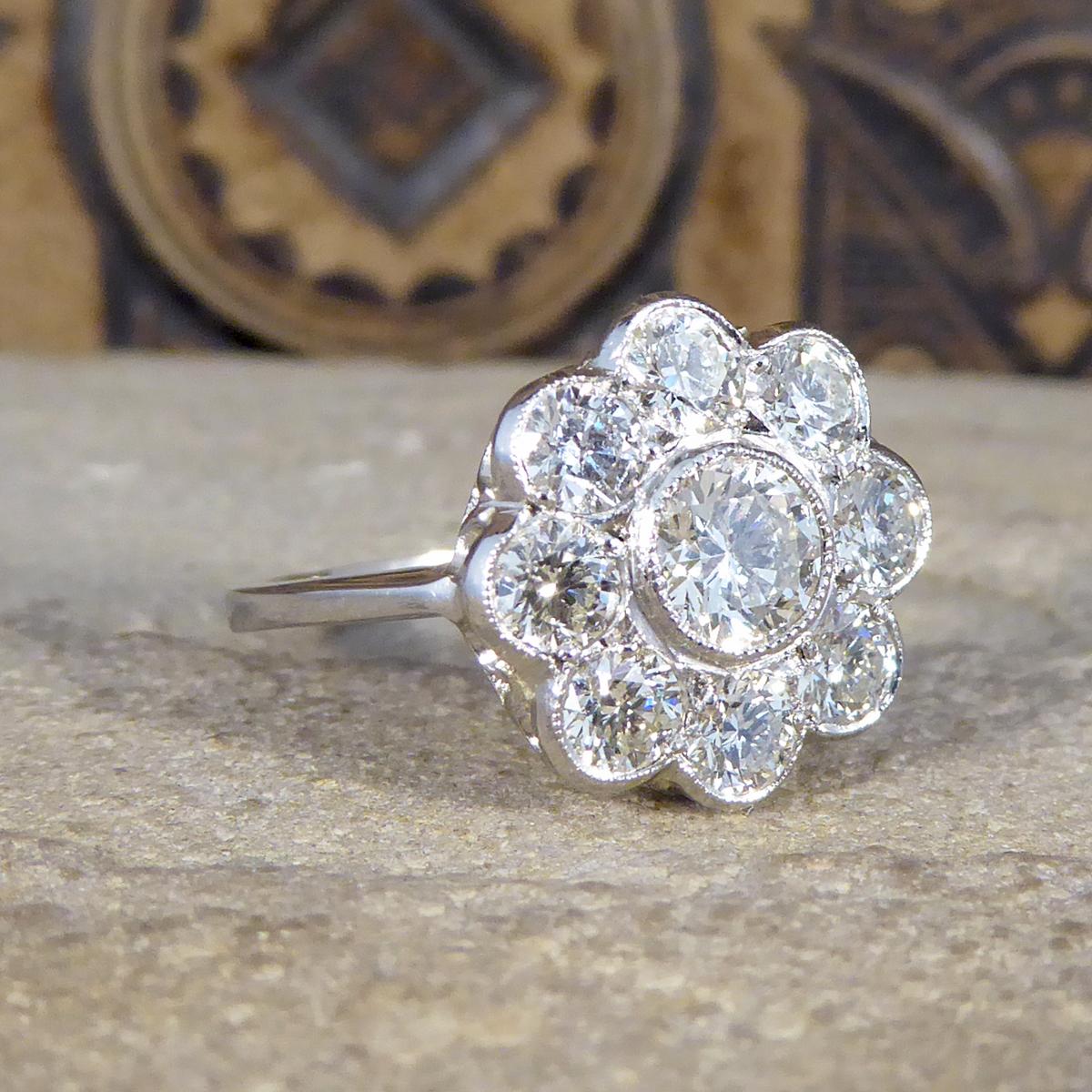 This fabulous Contemporary Daisy cluster ring dazzles on the hand with a total of 1.70ct of Diamonds. With the centre stone being a Round Brilliant cut stone weighing approximately 0.50ct, surrounded by 8 Round Brilliant cut Diamonds weighing