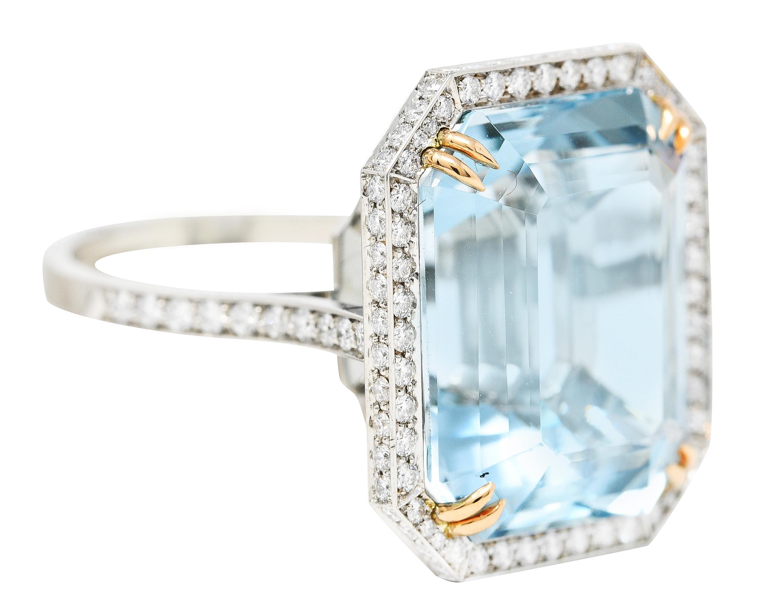 Cocktail ring features an octagonal face centering an emerald cut aquamarine with a barrel faceted crown. Transparent with medium light greenish blue color while weighing approximately 16.50 carats. Set by 18 karat yellow gold split prongs.