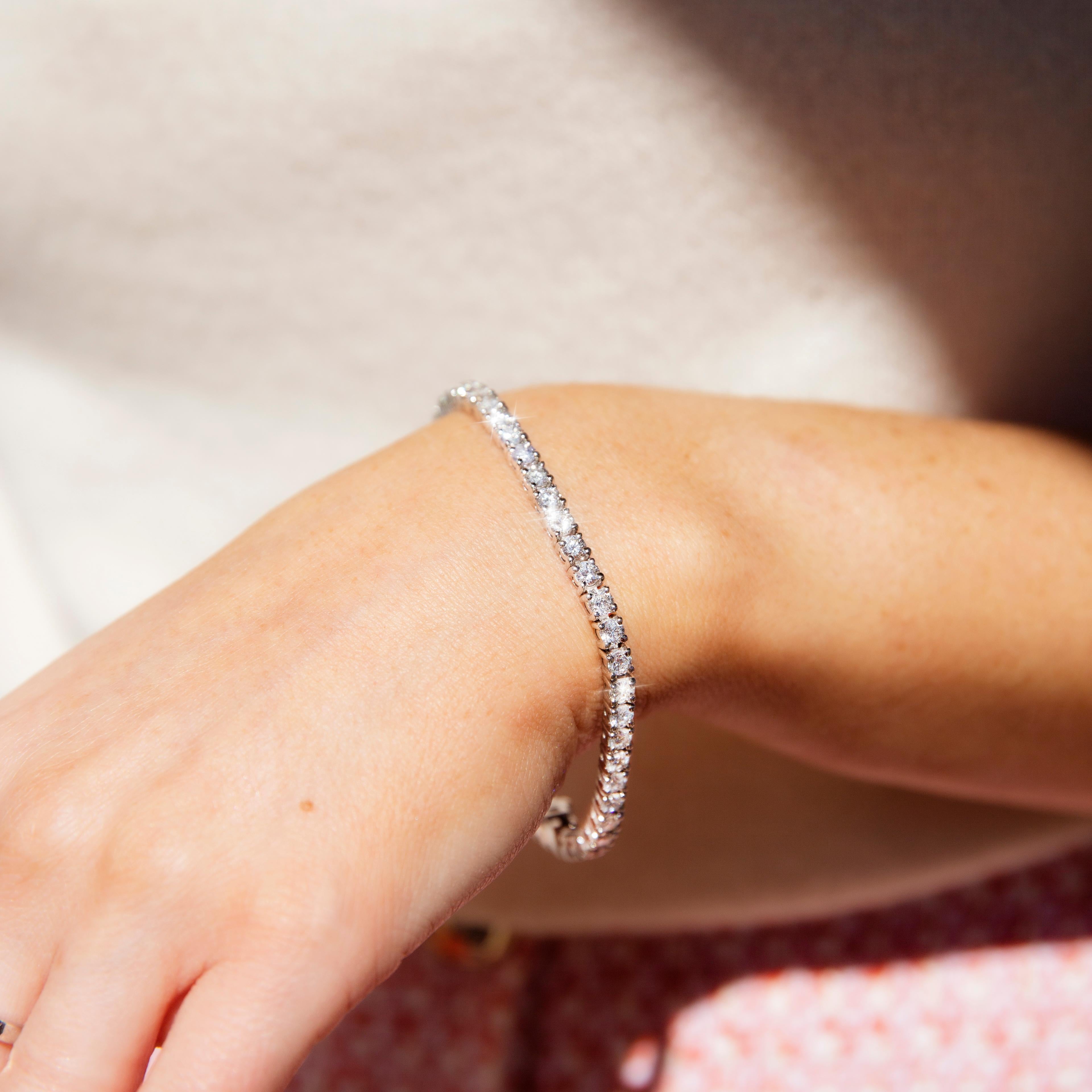 Thoughtfully crafted in 18 carat white gold, this wonderful contemporary tennis bracelet is an alluring sequence of forty-eight scintillating round brilliant diamonds in four-claw settings and finished with an elegantly concealed box clasp and a