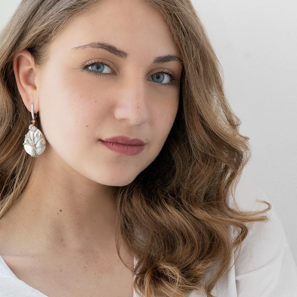 Behold the grandeur of these massive freshwater pearl earrings -- a true marvel of artistry and creativity. Crafted with exquisite skill, these earrings are a masterpiece that exude opulence and elegance.

On each earring, a large pearl serves as