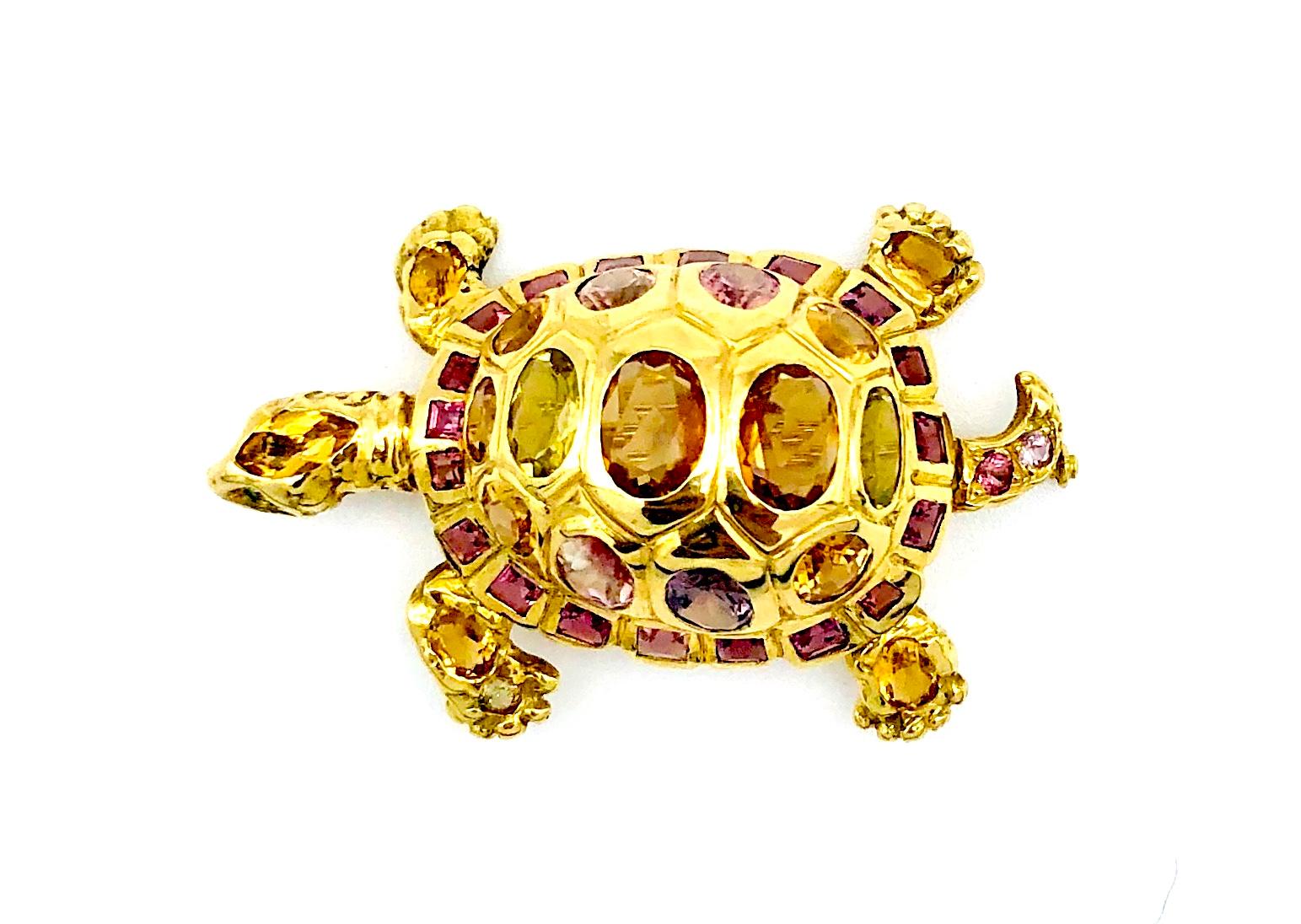 This wonderfully chunky and excellently modelled 18 karat turtle has been mounted as a pendant / brooch by Munich master-goldsmith, Günther Hahn. The lovely animal is decorated with 40 different coloured oval and square cut tourmalines. 
The colours