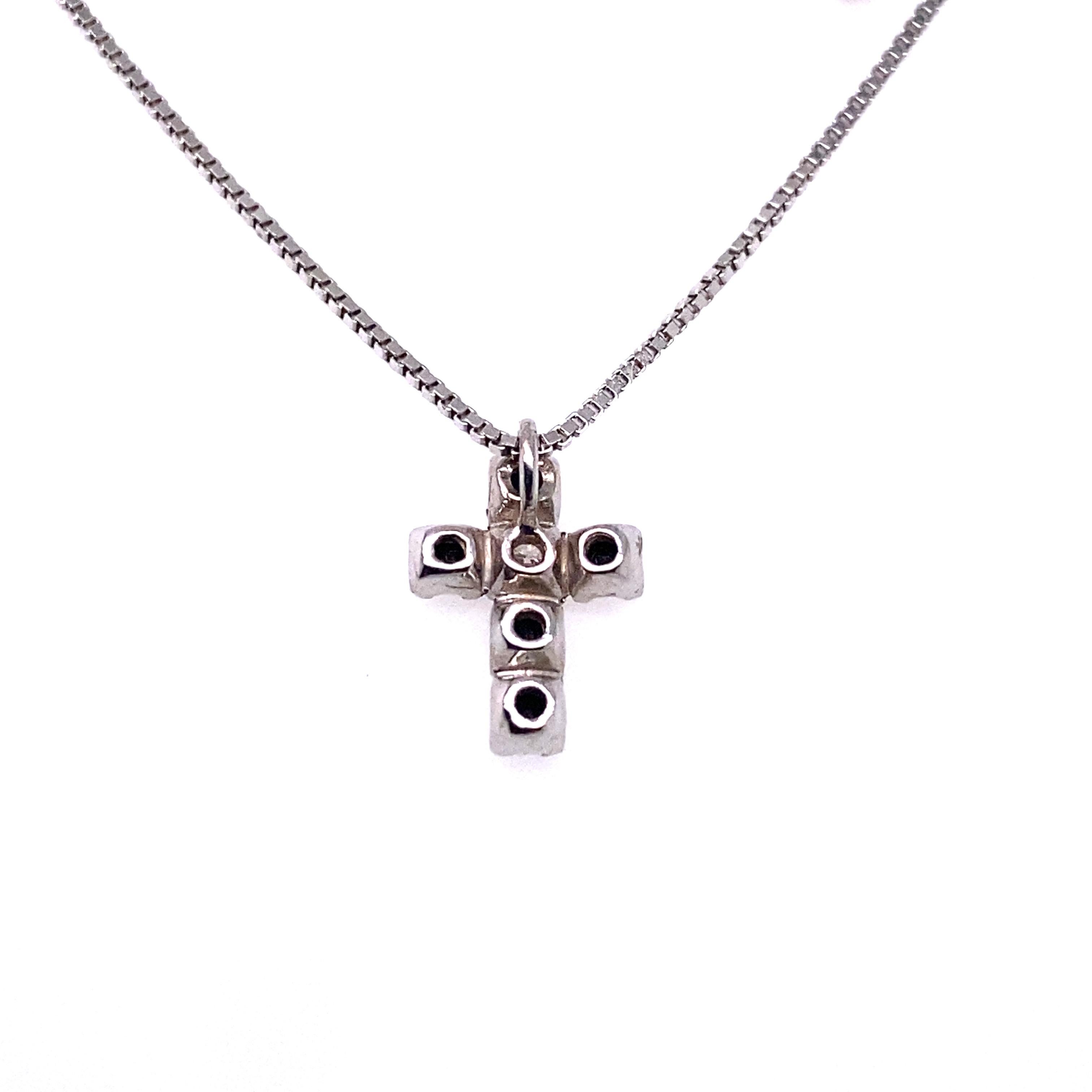 A beautiful contemporary cross with a white diamond (G VS) and black diamonds set in 18-karat white gold. The chain is a delicate 18-karat white gold. The pendant measures .7-centimetres across, and 1-centimetre long. 

Are you looking for a set?