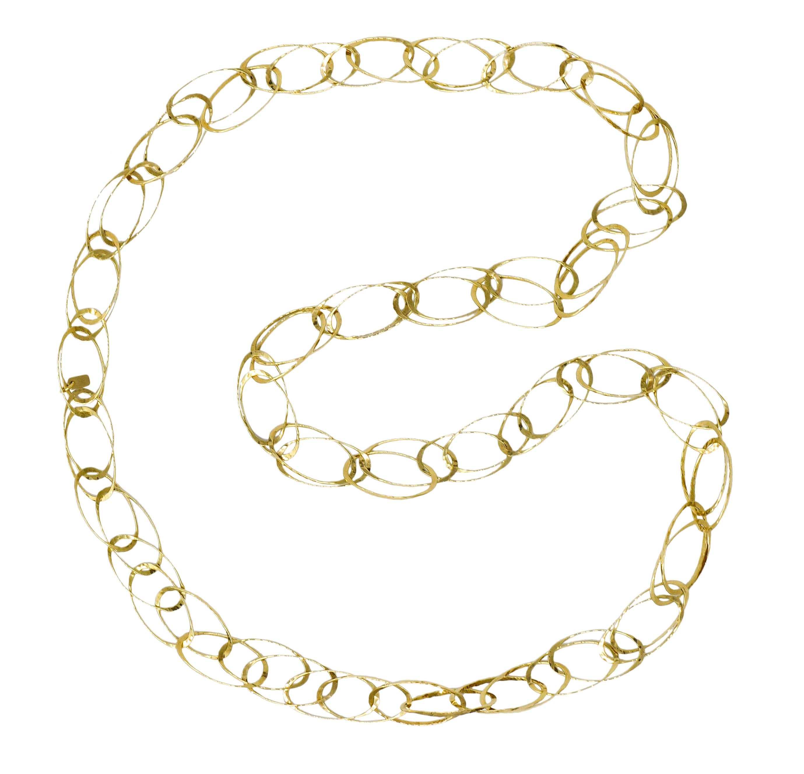 Necklace is designed as intersecting elongated oval links

Thin and with a hammered finish

Completed by logo link with maker's mark and stamped 18K for 18 karat gold

Circa: 2000s

Length: 34 inch (eternal loop)

Width at widest: 3/4 inch

Total