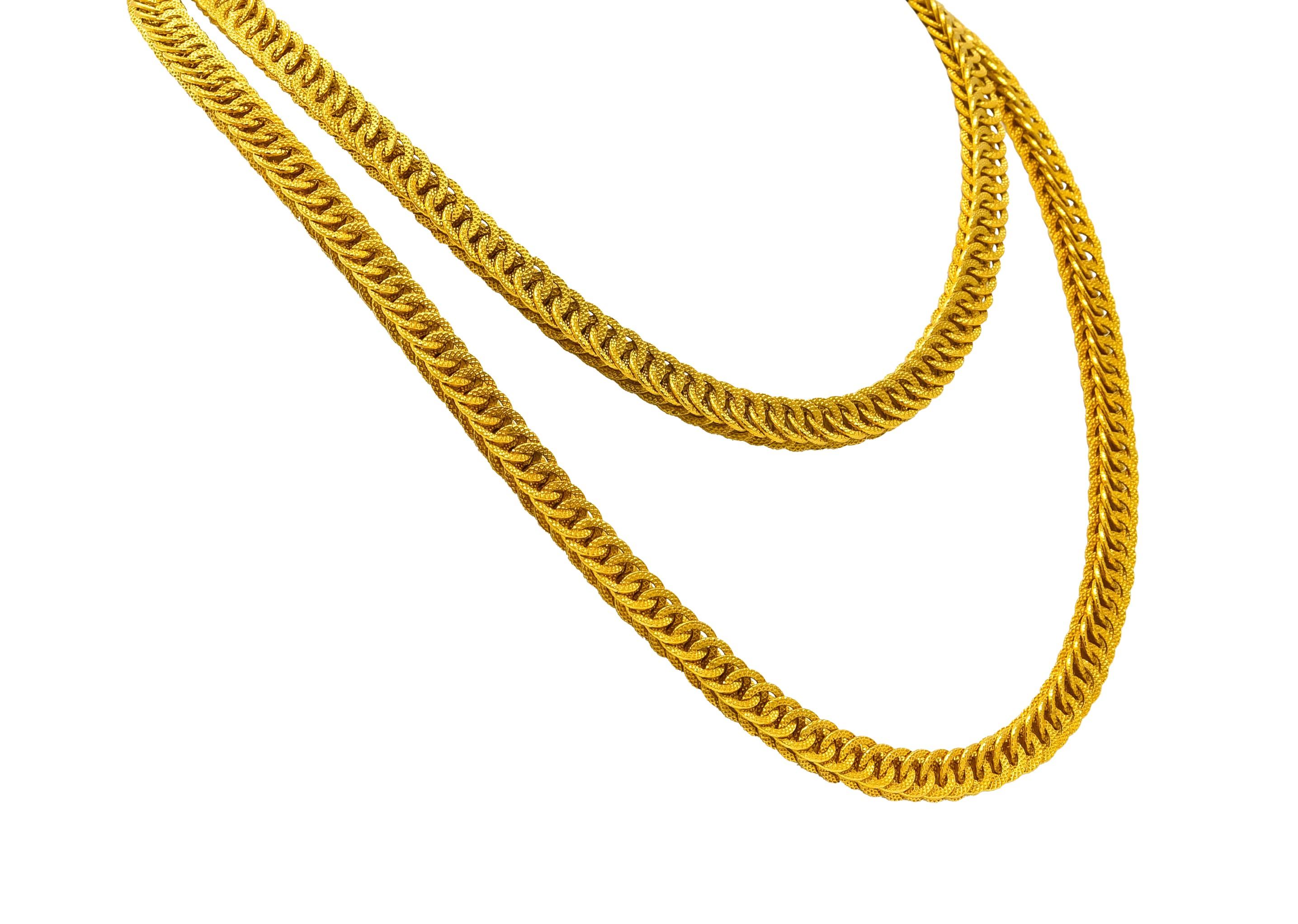 Necklace comprised of two rows of overlapping disks, hand woven together

Articulated disks feature matte gold finish with a deeply engraved faceted texture

Completed by concealed clasp and figure eight safety

With Italian assay mark and stamped