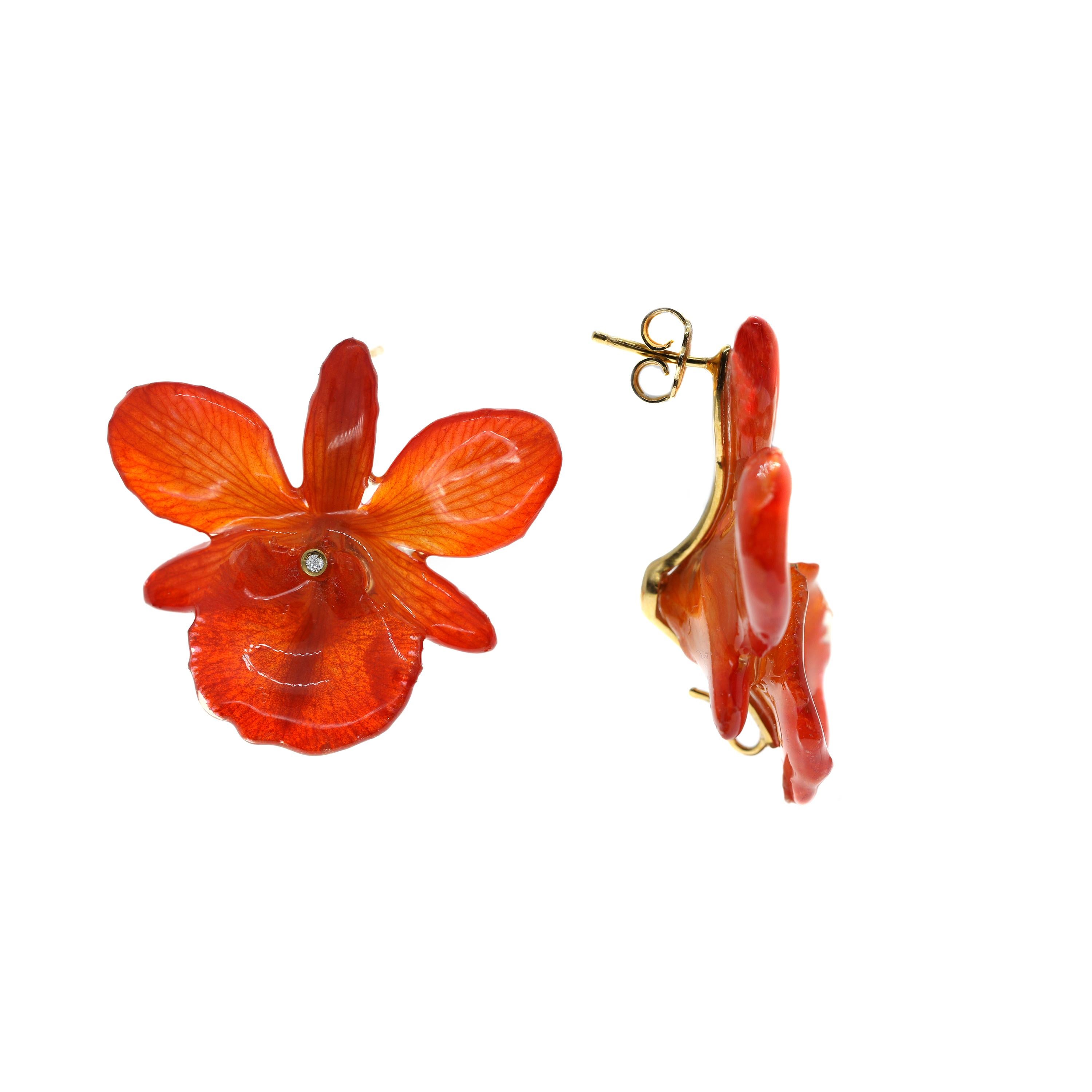 A vibrant pair of floral earrings masterfully created entirely by hand. Each earring features a perfect bloom from a real orchid, which has been transformed to preserve its beauty for eternity. 

The orchids post-backed earrings are approximately