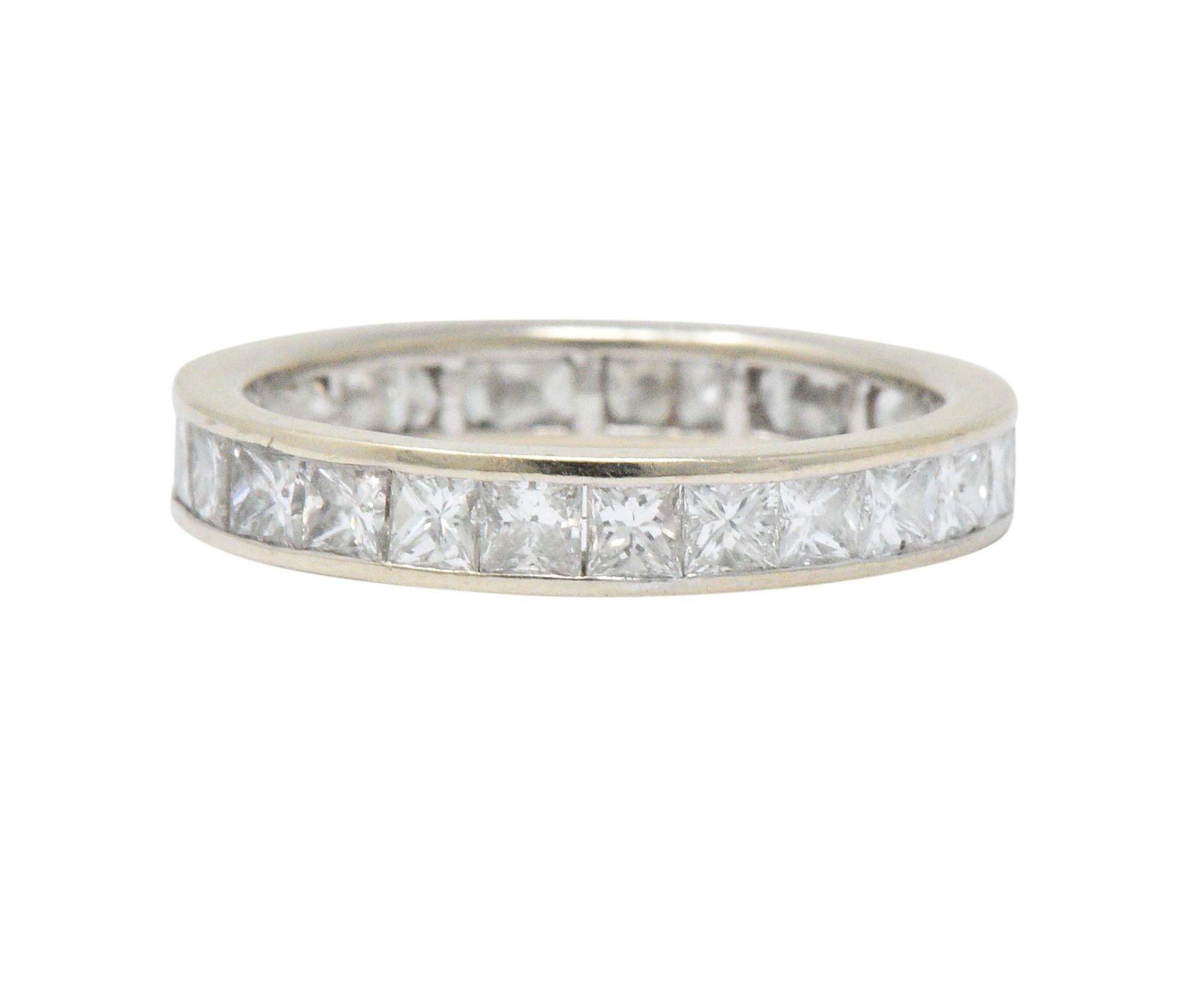 Sleek band style ring channel set fully around with princess cut diamonds

Weighing approximately 1.80 carats with H/I color and VS clarity

Tested as 14 karat white gold

Circa: 1990s

Ring Size: 5 3/4 & not sizable

Measures: 3.3 mm wide and sits