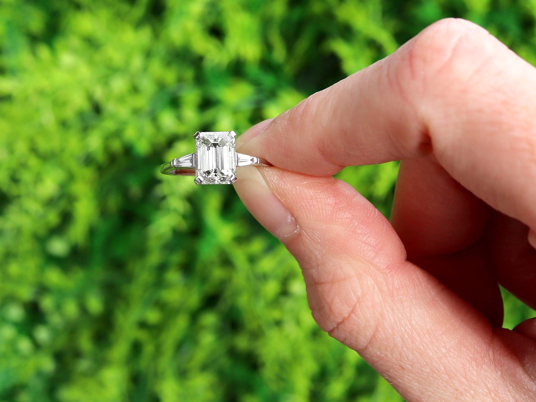 A stunning, fine and impressive contemporary 1.85 carat emerald cut diamond solitaire ring in platinum; part of our emerald cut diamond rings collections.

This stunning, fine and impressive contemporary diamond engagement ring has been crafted in