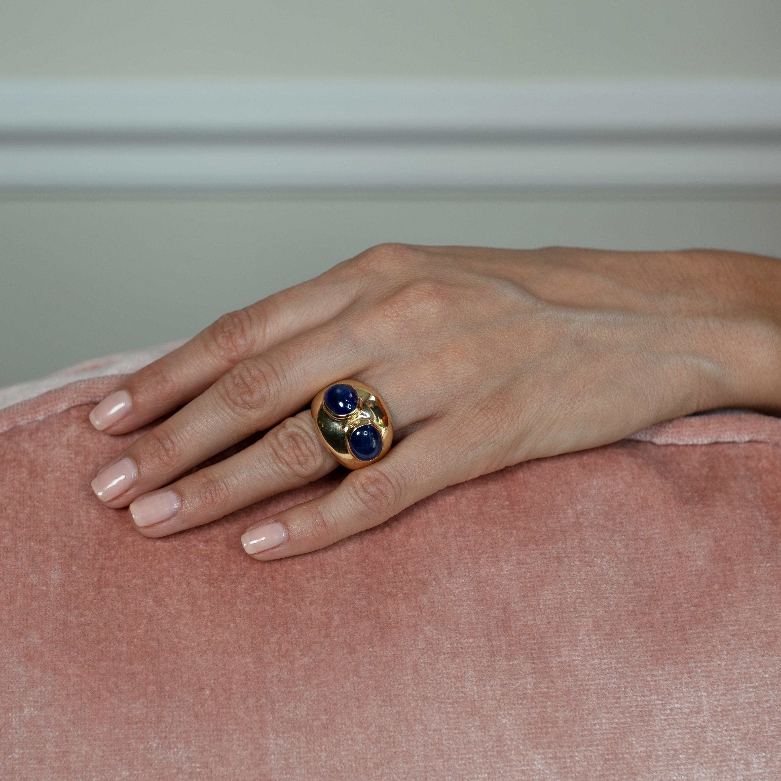 A bold and fabulous gold cocktail ring in bombé design with double blue for you. The substantial band is sleekly styled in 18ct yellow gold with a soft satiny finish, leading to a wide gallery with lots of presence on the finger. Two juicy