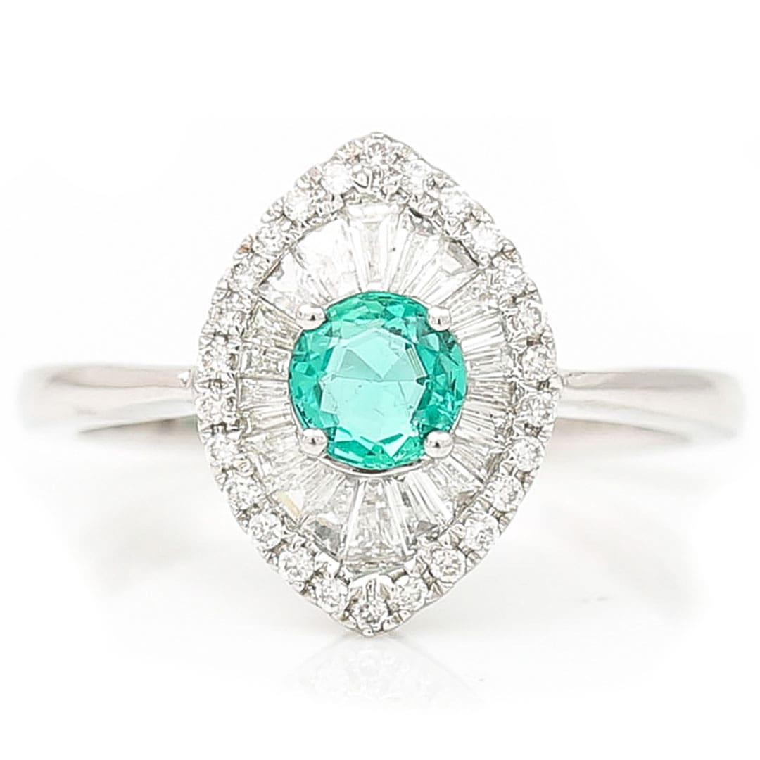 A stunning contemporary 18ct white gold emerald and diamond engagement ring which is as good as new and most likely never been worn. The beautiful ring has a central set round mixed cut emerald of approx 0.51ct around which are masterfully tension