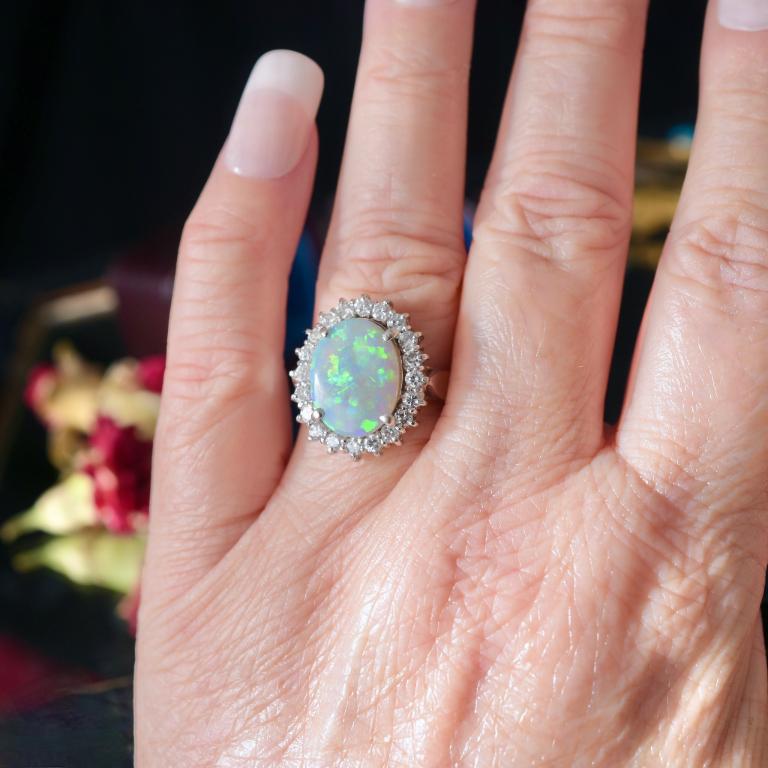Independent valuation included with purchase for $14,500 AUD.

Superb solid dark Opal ring dating to around the 1980-2000’s with one of the most beautiful Opals we have seen.  Exhibiting a gorgeous play of colour displaying greens, blues, golds,