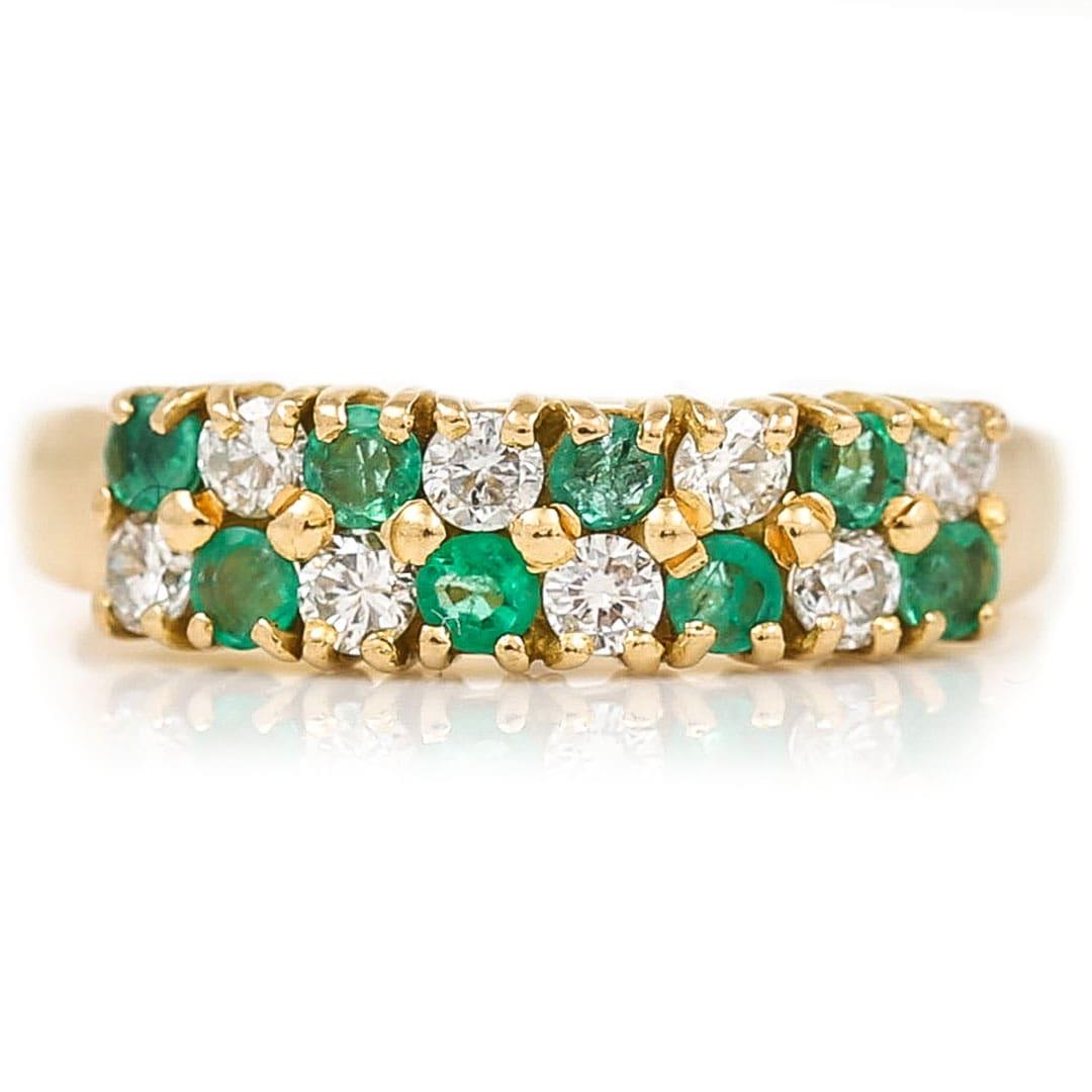 An 18ct gold emerald and diamond ring inlaid with 16 gemstones arranged into a checkerboard design. The sparkling brilliant cut diamonds sit snugly alongside the bright green emeralds all set within 18ct yellow gold. The diamonds total an estimated