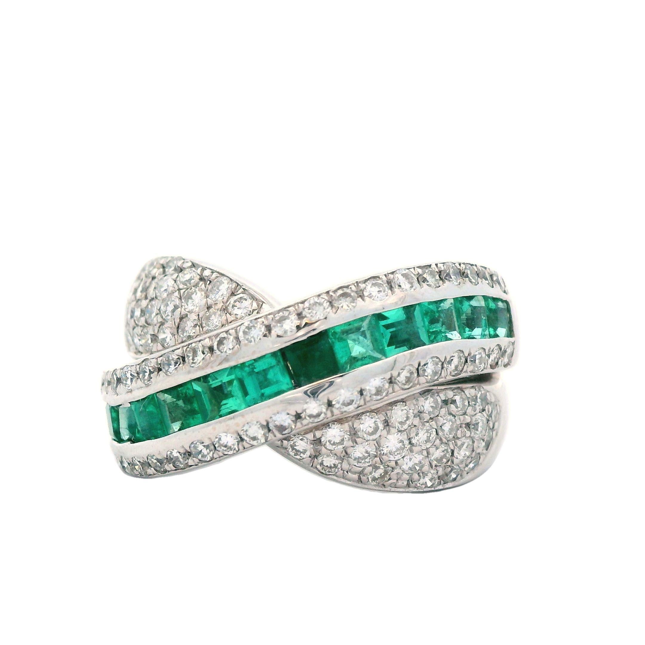 Presenting a stunning contemporary ring adorned with vivid green emeralds and sparkling white diamonds arranged in an elegant crossover style. This eye-catching piece is sure to attract attention from across any room. Ideal for those seeking a