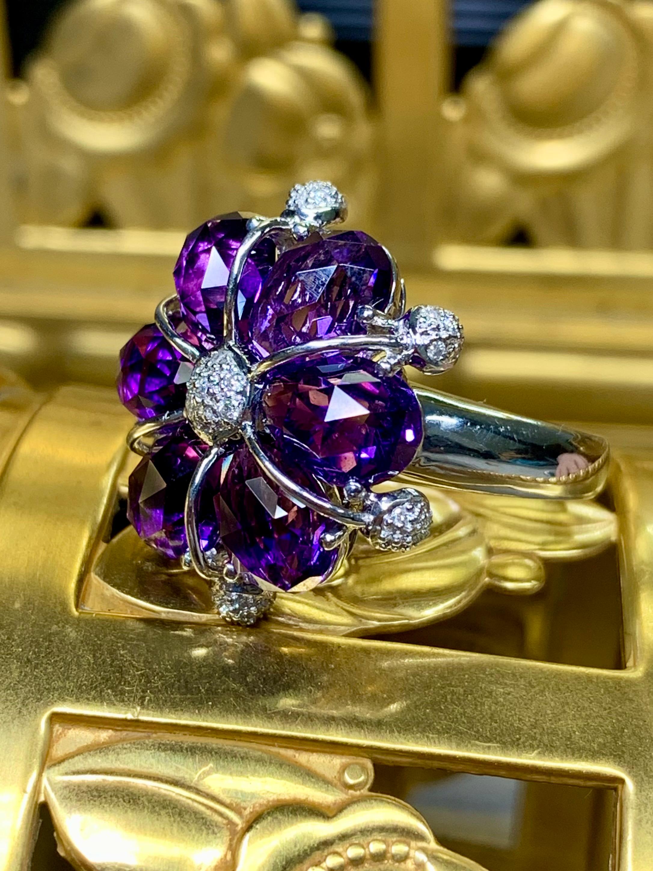 A well done contemporary cocktail ring done in 18K white gold and set with 3.71ctw in fancy cut natural amethyst and .16ctw in G-I color Vs1-2 clarity round diamonds.


Dimensions/Weight:

Ring measures 1” in diameter and weighs 8.6g. Size 9