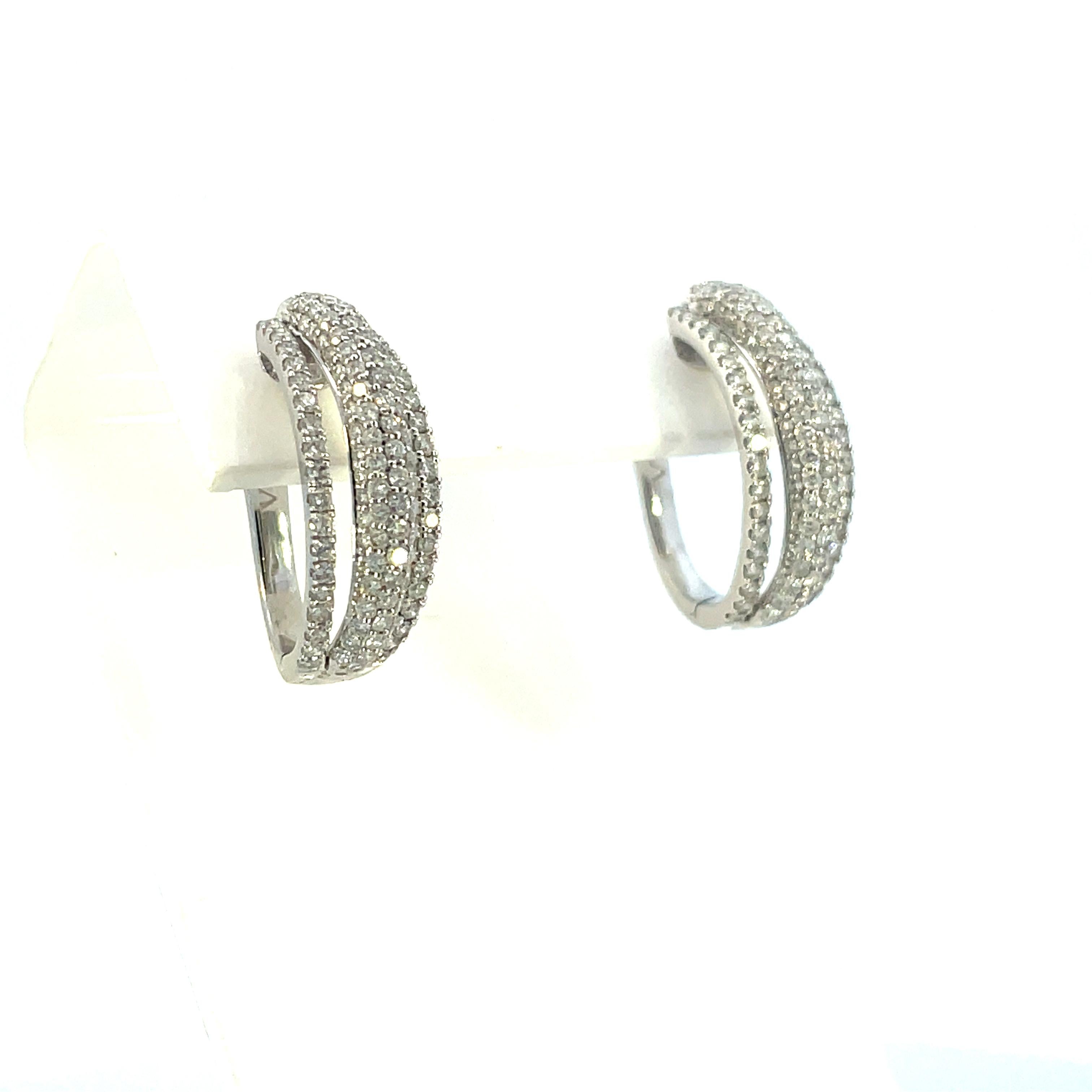 This is an incredible pair of Contemporary 18K white gold  earrings featuring three rows of finely set SI1 in clarity and F/G colored round diamonds. 

These white gold earrings feature 3 sets of bands containing five rows of diamonds, each