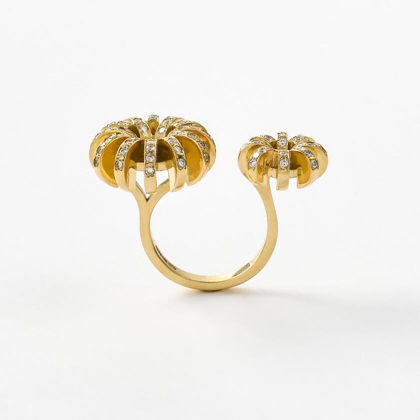 The 'Double Flower', ring is crafted in 18k gold, hallmarked in Cyprus. This stunning, contemporary  piece, comes in a highly polished finish and features white, VS Diamonds totalling to 0,80 Cts . The ring is designed to ergonomically comfortably 