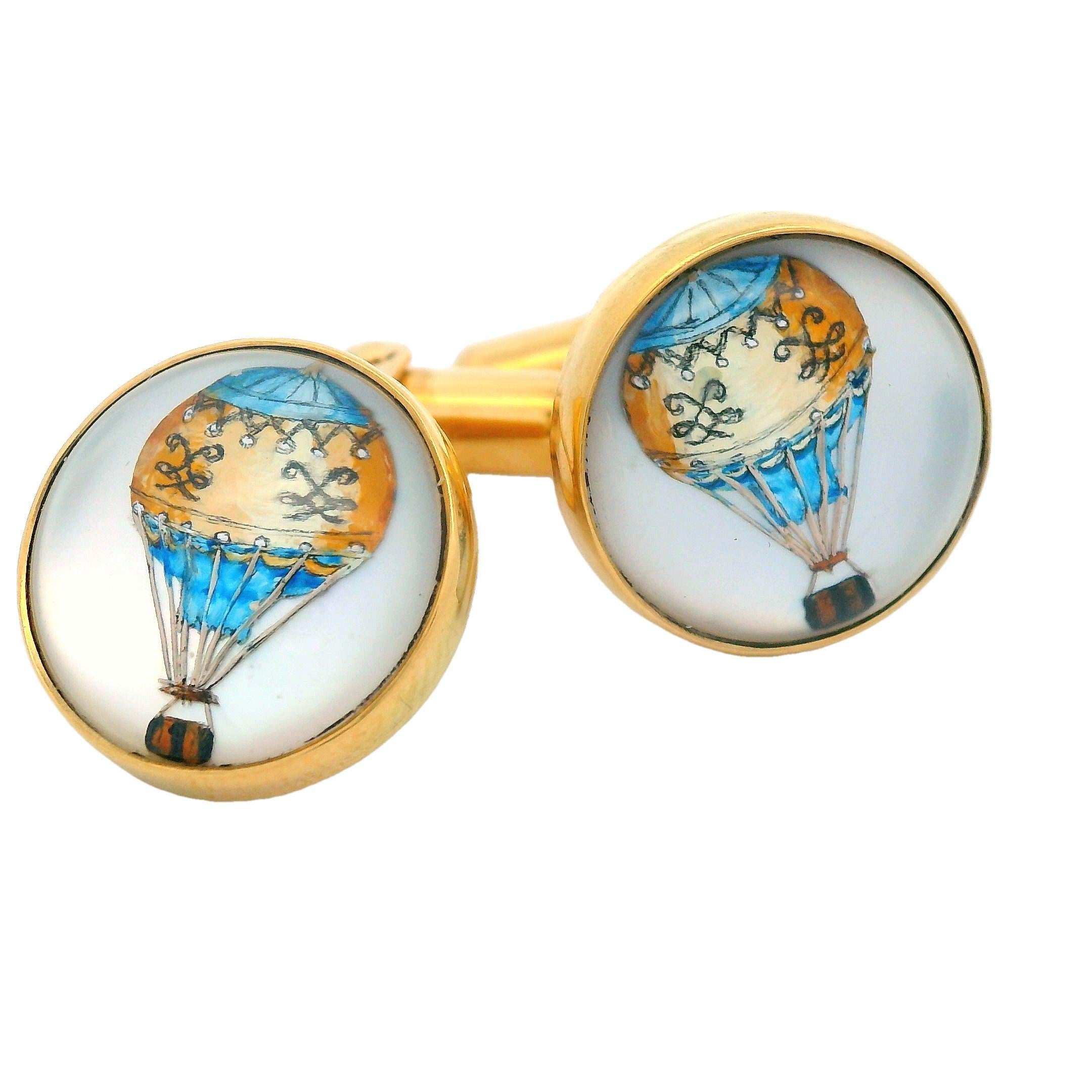 This beautiful pair of cufflinks showcase matching hot air air balloons with vivid, life-like detail. The soft white background of the cufflinks interacts with light in a mesmerizing way and makes the hot air balloons appear as if they are floating