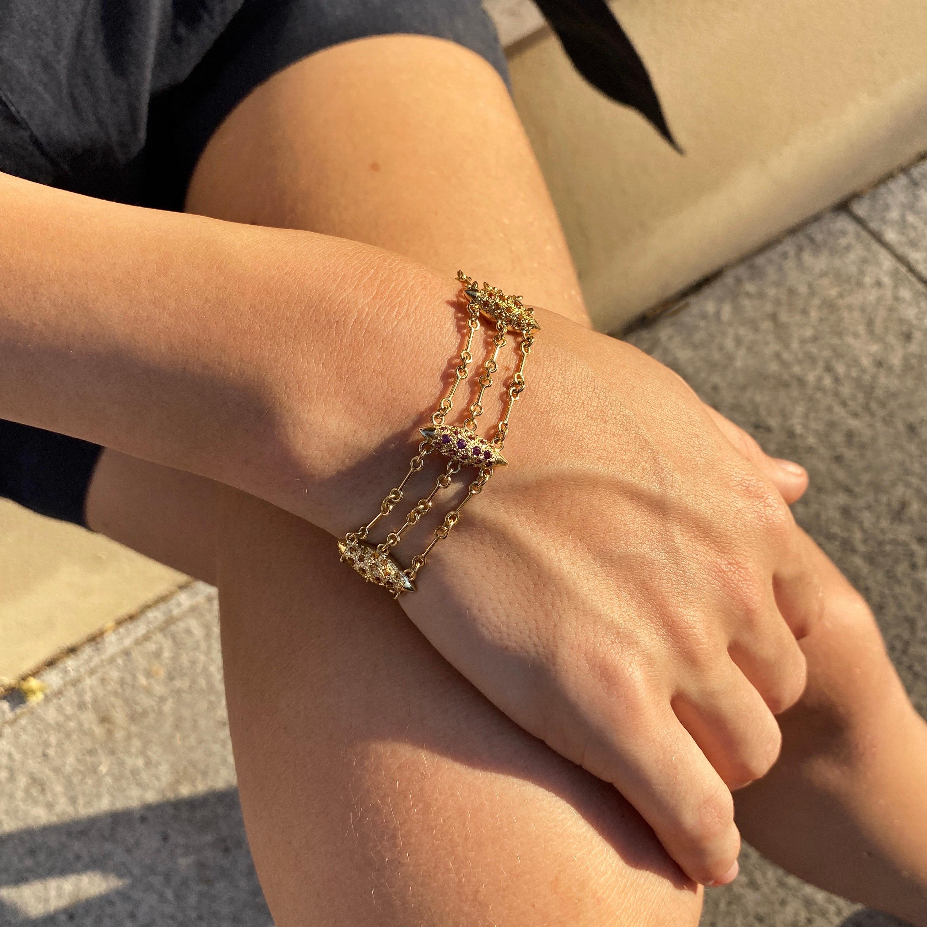 The ‘Six Grain’, chain bracelet is crafted in 18K gold hallmarked in Cyprus. This impressive, ultra chic chain bracelet comes in a highly polished finish and comprises six individual grains set with Madeira Citrines, 0,9 Cts and Rhodolite Garnets,