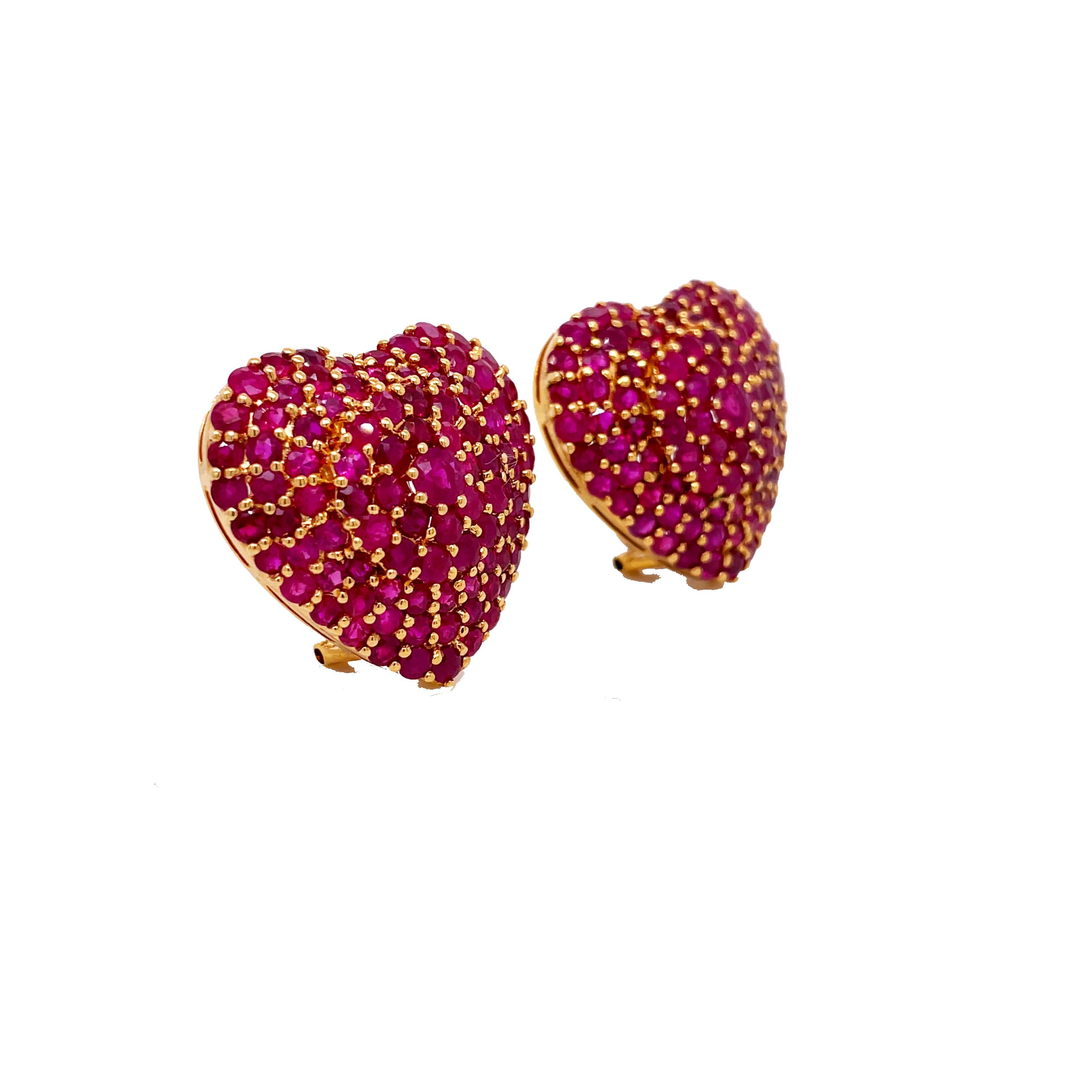 This is an absolutely killer pair of clip-on earrings that are guaranteed to spark a conversation that features dazzling vivid rubies set in 18K Yellow Gold. Each heart is beautifully set with 4.28 cttw round rubies and is complemented by the bright