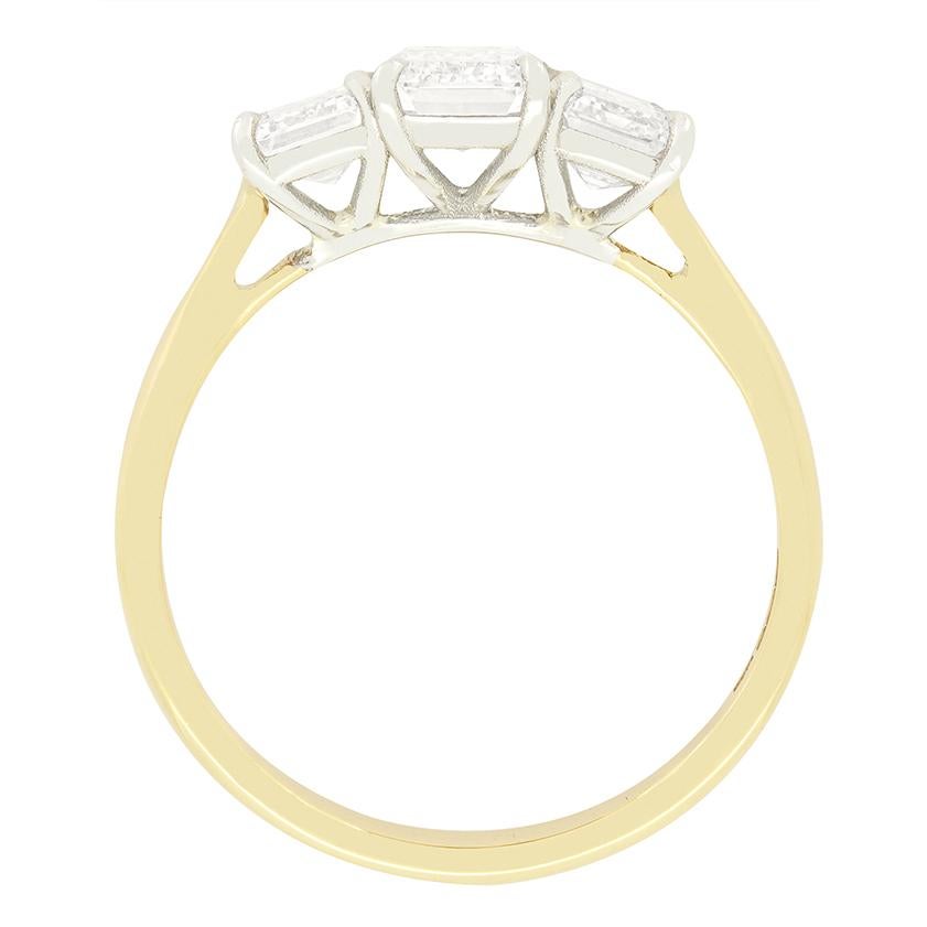 A trio of elegant emerald cut diamonds are on display in this contemporary three stone ring. The central diamond sits the largest at 0.90 carat with the flanking pair being 0.50 and 0.55 carat respectively. Each stone comes fully GIA certified with