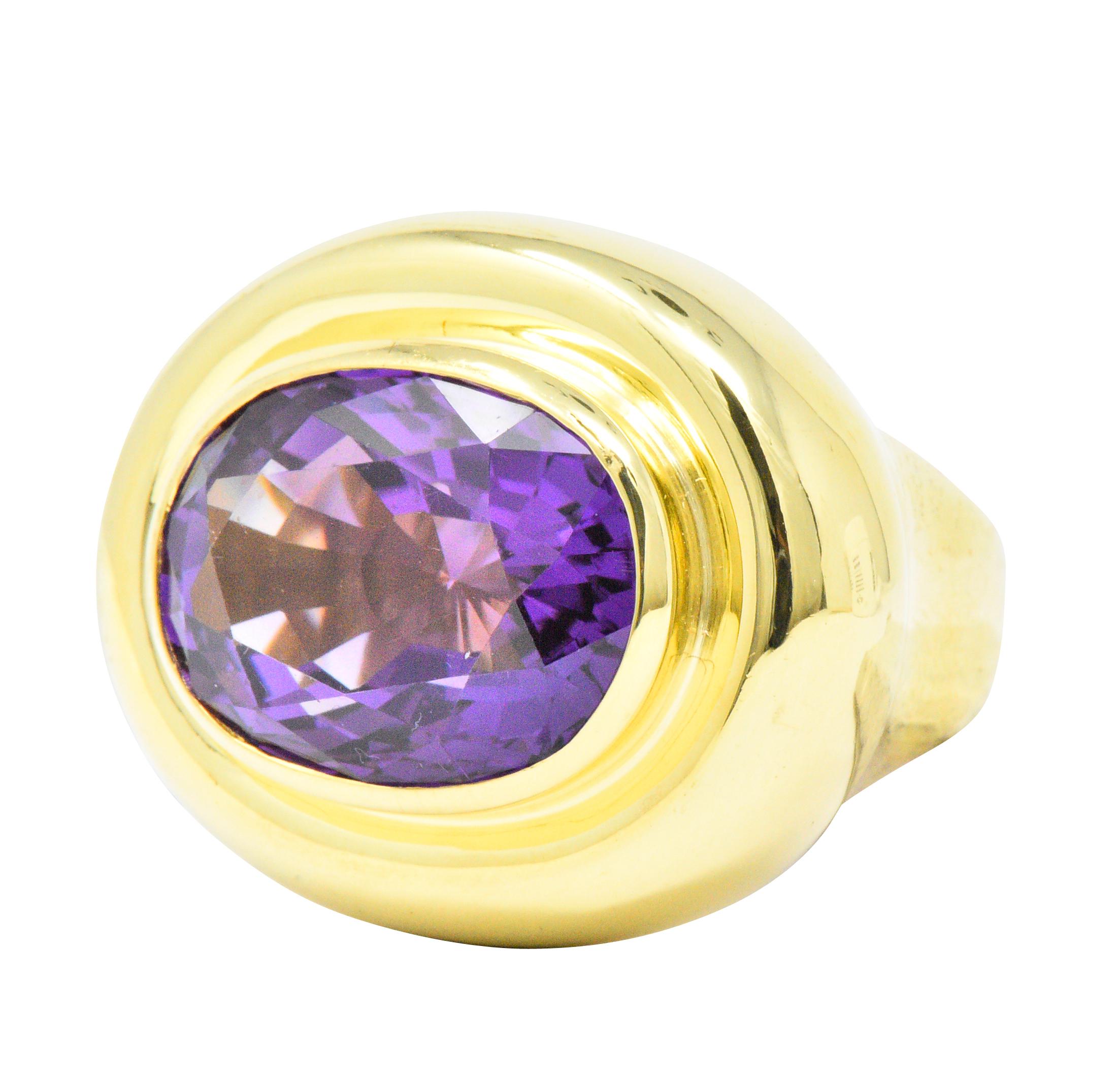 Centering an oval cut amethyst weighing approximately 20.00 carats total, bright vivid purple

Bezel set in a high polished rounded tiered mount

With inner sizing ring to accommodate smaller finger sizes

Ring Size: 6 1/2 & Not Sizable

Top