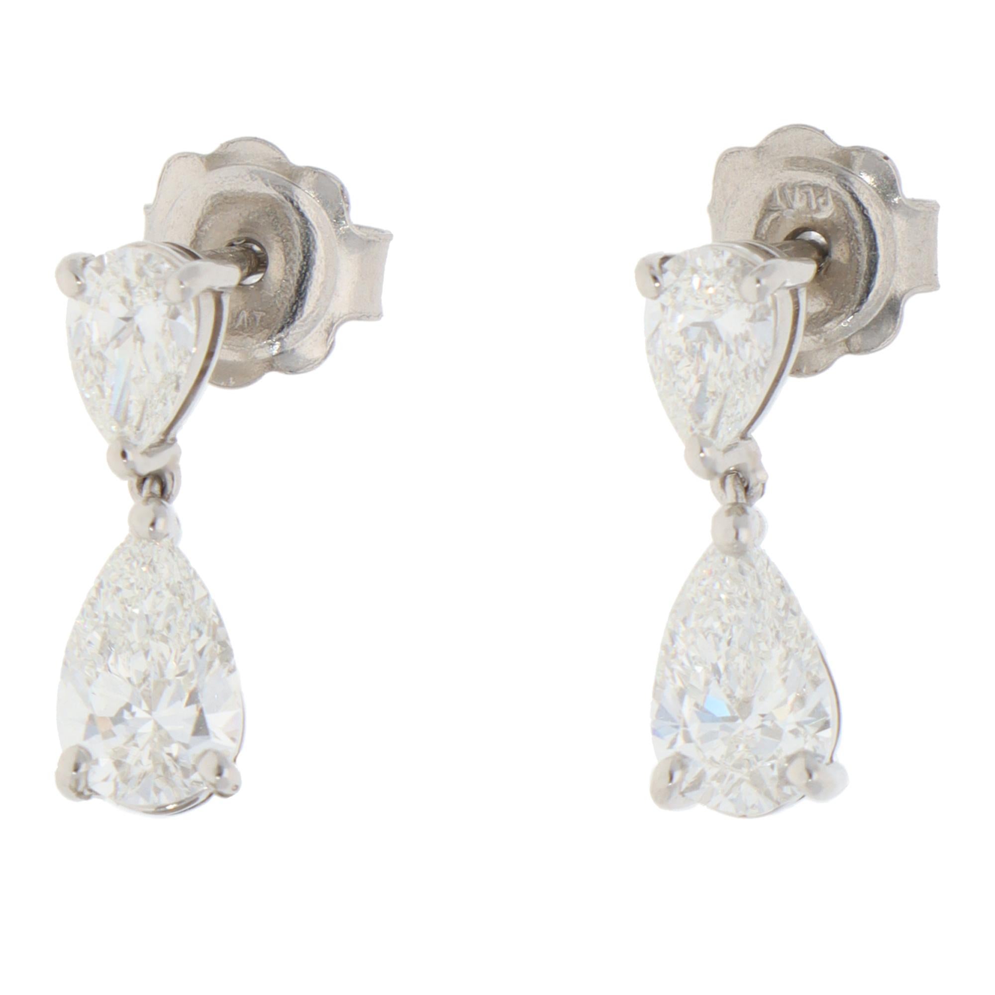 An elegant pair of contemporary diamond drop earrings set in platinum.

Each earring is composed of 2 pearl-shaped brilliant-cut diamonds. The bigger diamond creates a dropping motif from the other diamond. The earrings are secured to reverse with a
