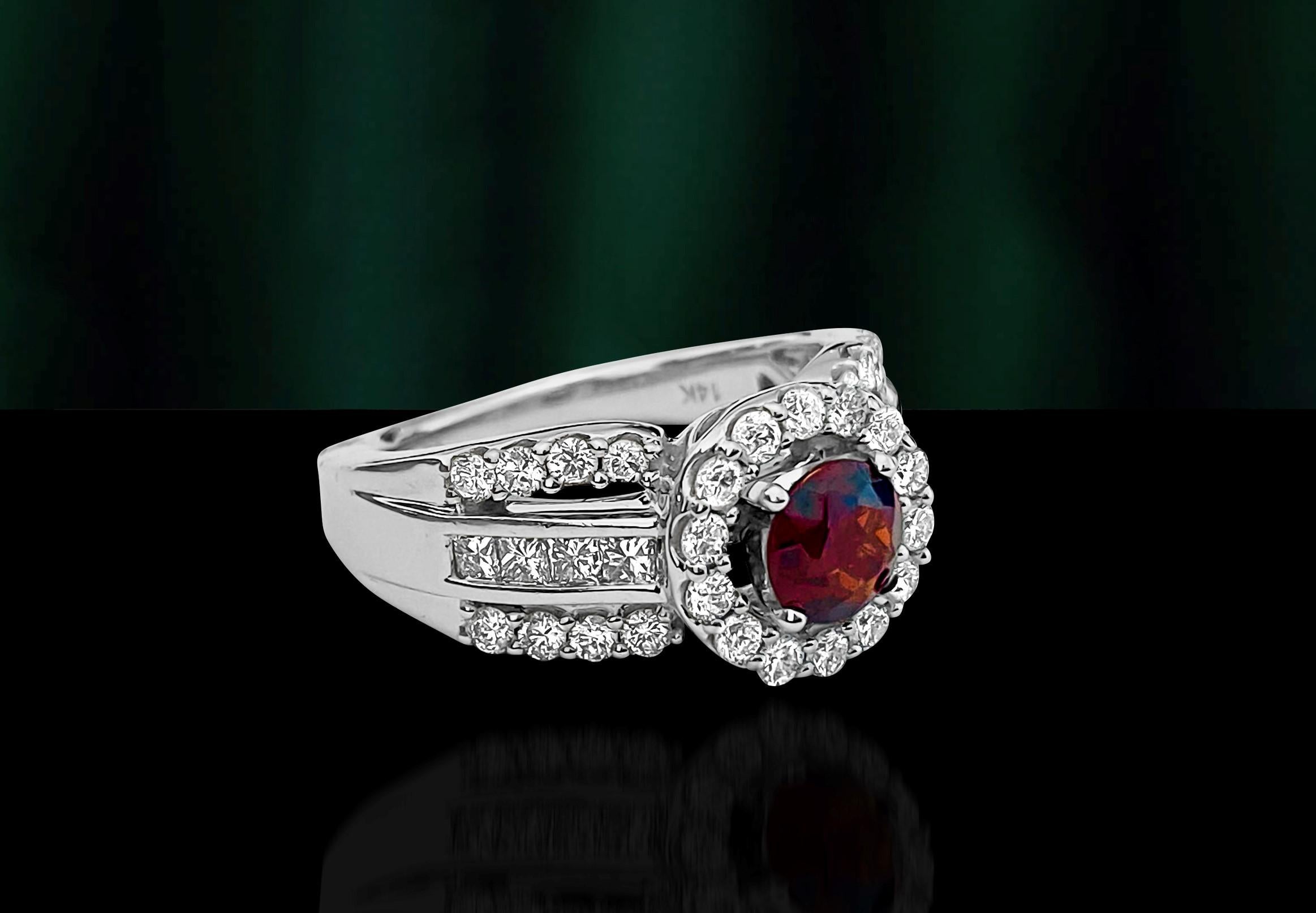 Metal: 14k white gold. 
Diamonds: 1.17cts total. Round brilliant cut. VS clarity and F-G color. 
Garnet: 0.85ct, 6mm approx. Round shape set in prongs. 
Total weight of the ring: 9.21 grams. Excellent luster and shine in the diamonds and garnet.